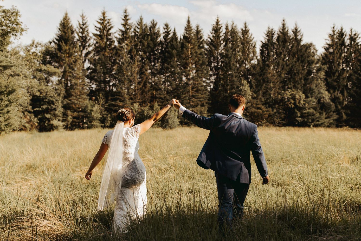 husband and wife walking into the distance as they celebrate their new marriage.
