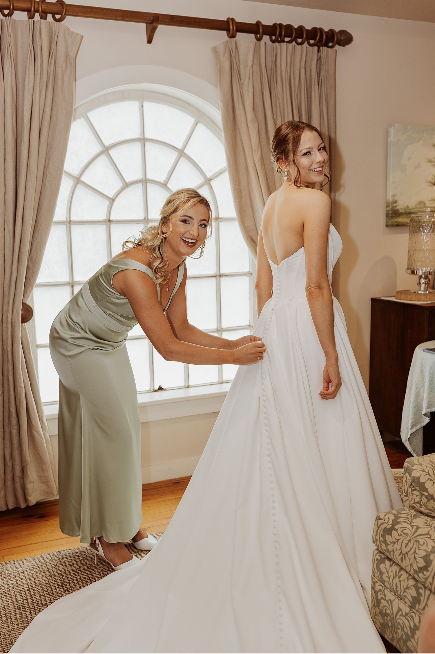 Bride getting dressed for her NH wedding at the Barn on the Pemi