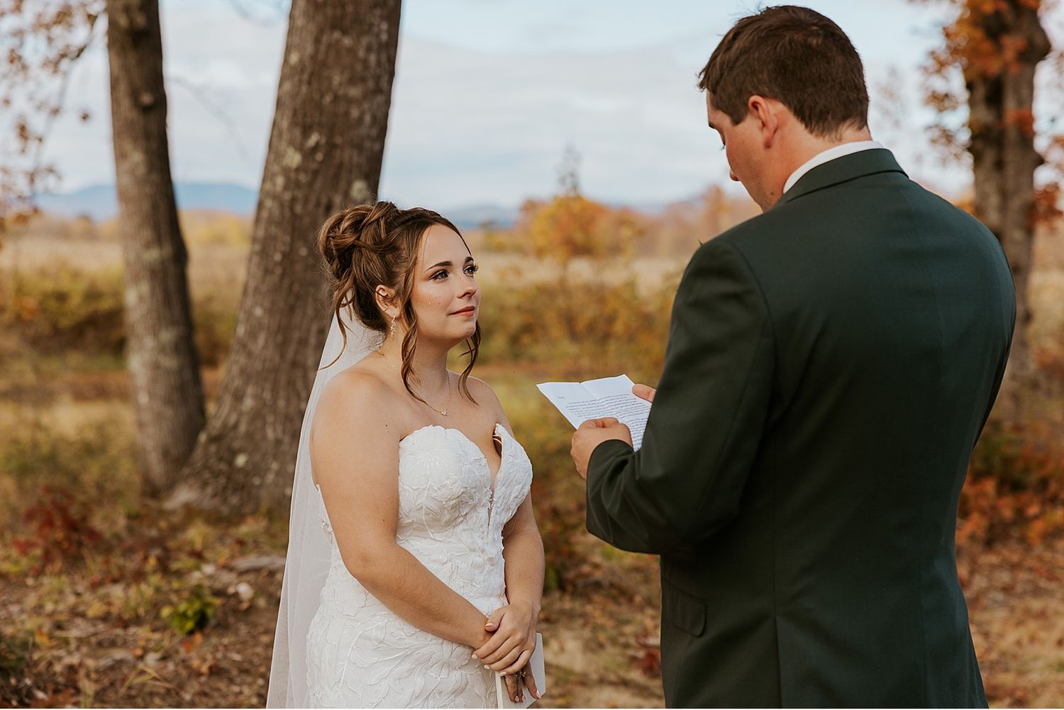 Bride and groom taking first look wedding photos at their fall Maine wedding