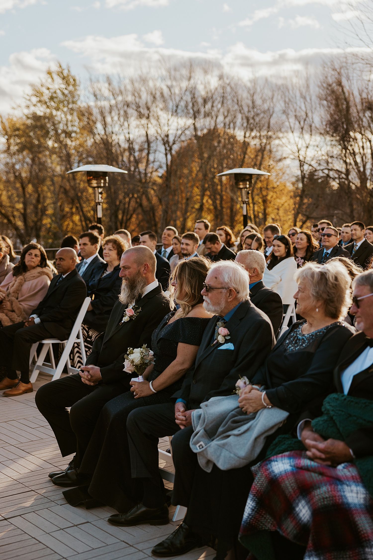 Guests seated at an outdoor wedding ceremony in the fall at Hyla Brook Estate in NH