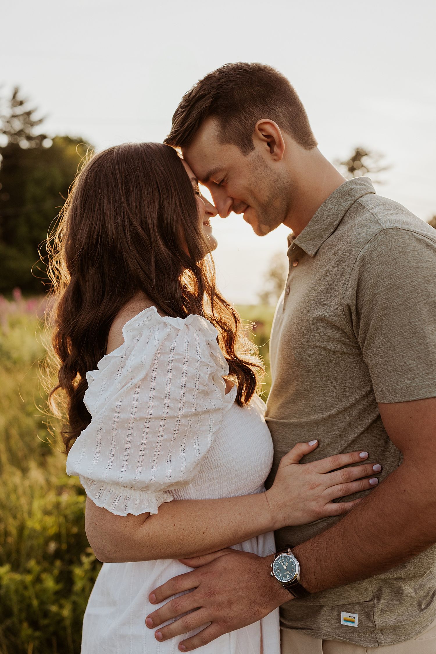 Couple taking engagement photos at sunset in the White Mountains in New Hampshire