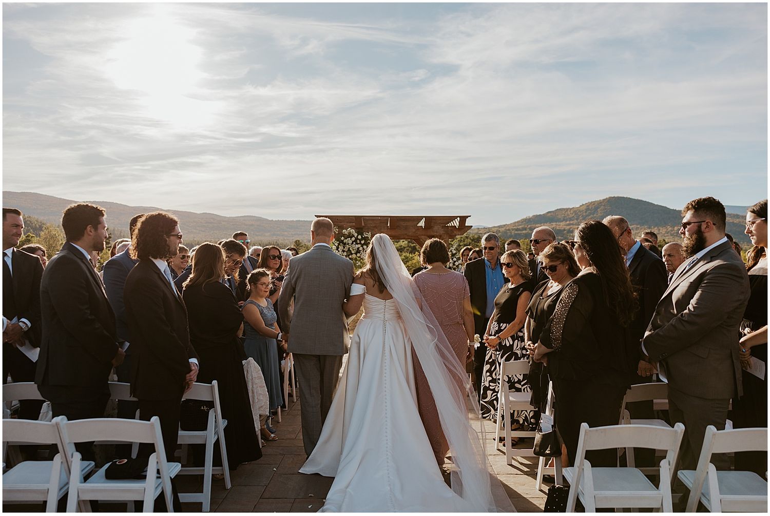 Bride walking down the aisle at her White Mountain wedding ceremony at Owl's Nest