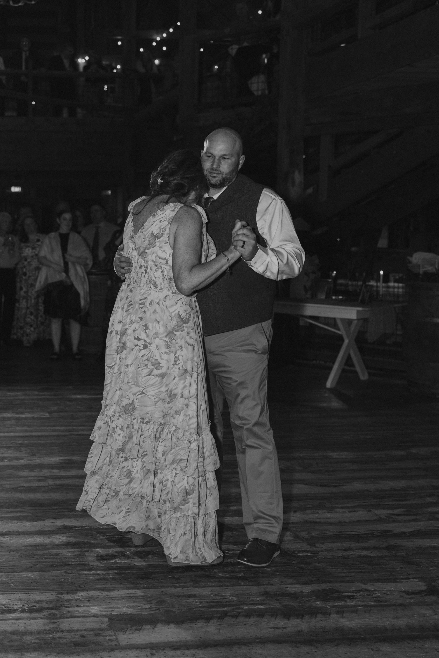 Black and white photo of couples dancing at an evening wedding reception.
