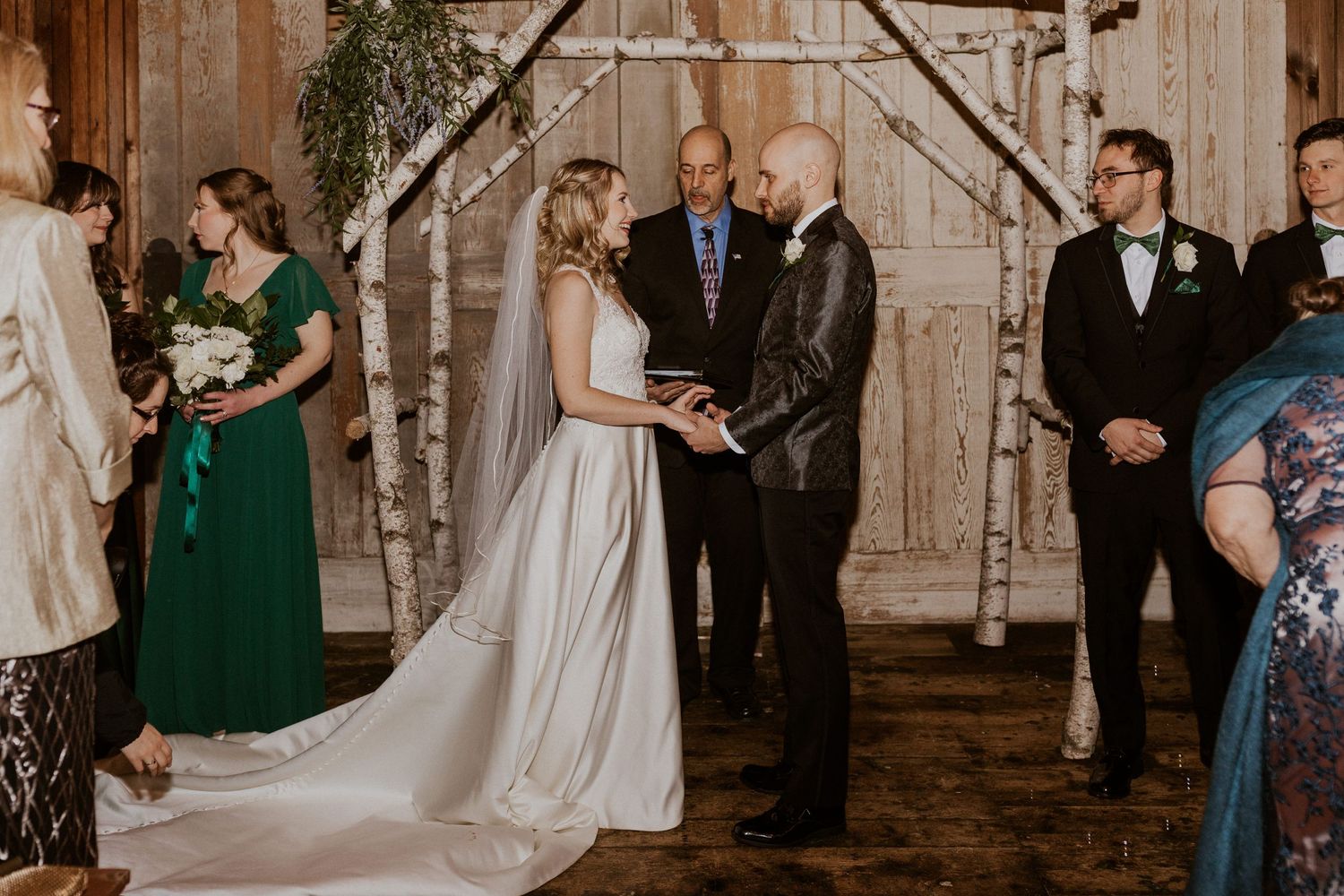 Deirdre and Brodie hand in hand during their wedding ceremony in Tamworth New Hampshire.