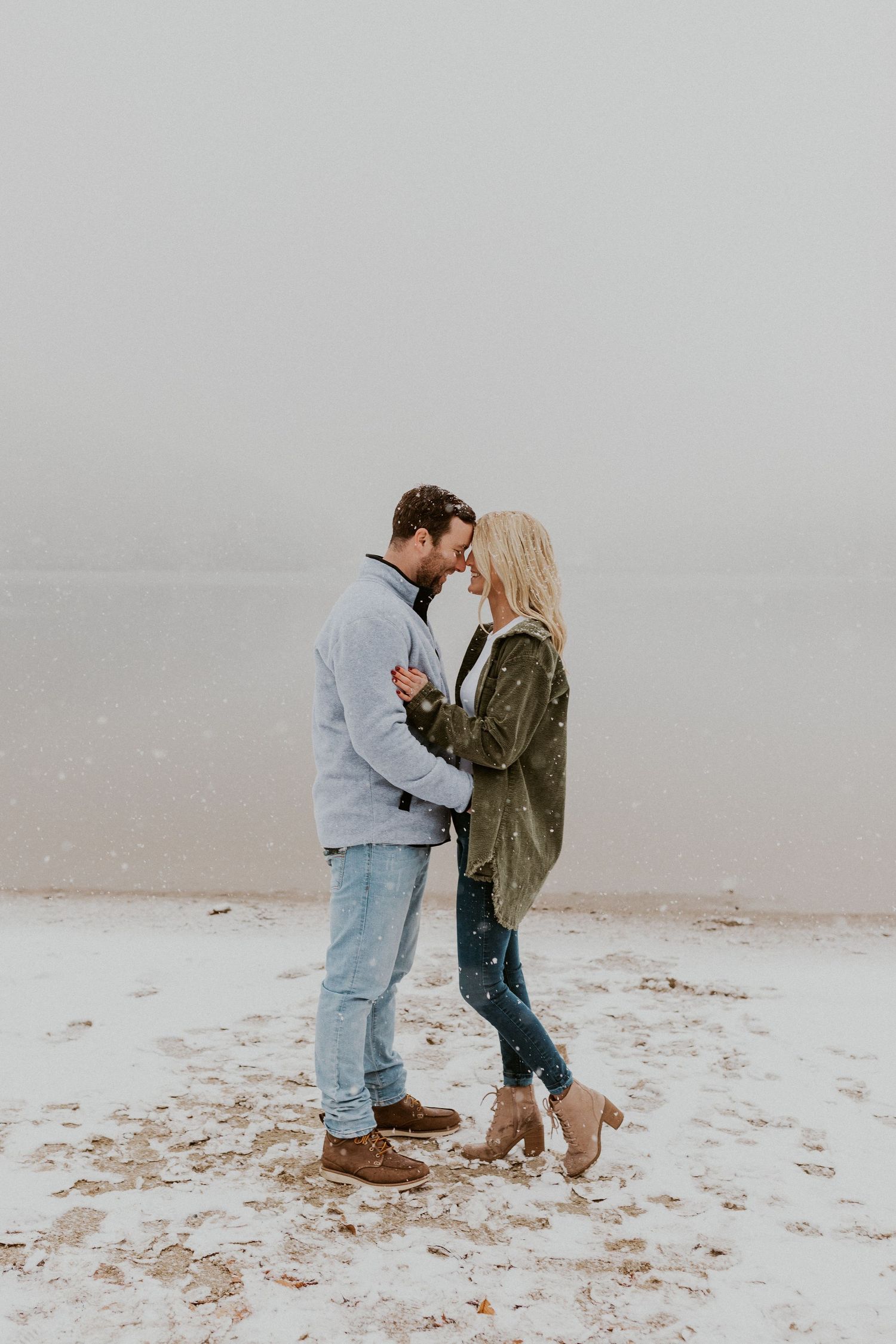 Newly engaged couple playfully posing for photos during their engagement session in Franconia New Hampshire.