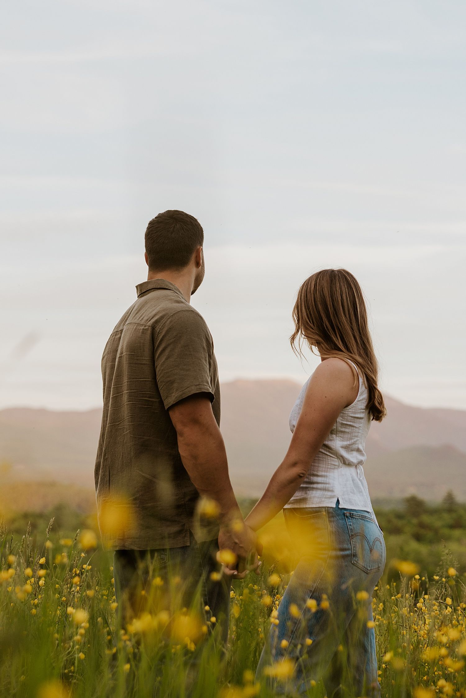 New Hampshire couple holding hands and taking engagement photos at golden hour