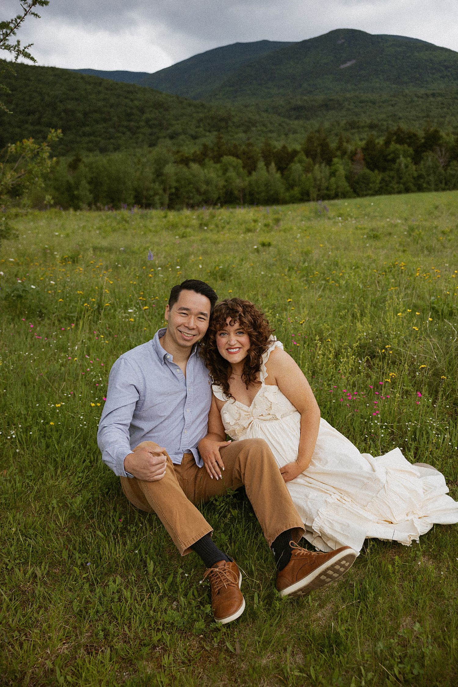 New Hampshire couple taking motherhood photos in a field in NH