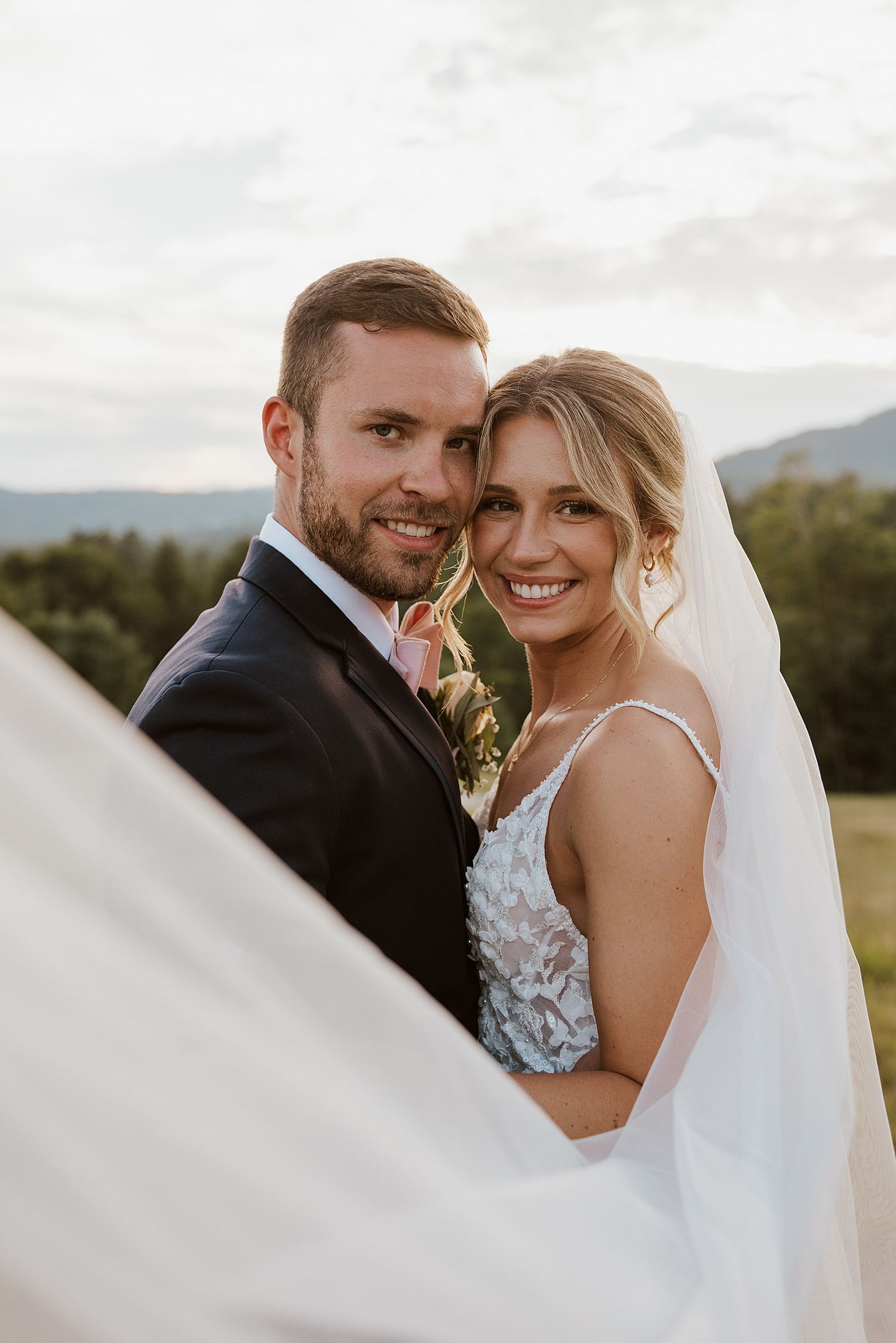 Bride and groom taking portraits outside at the Owl's Nest Resort in New Hampshire