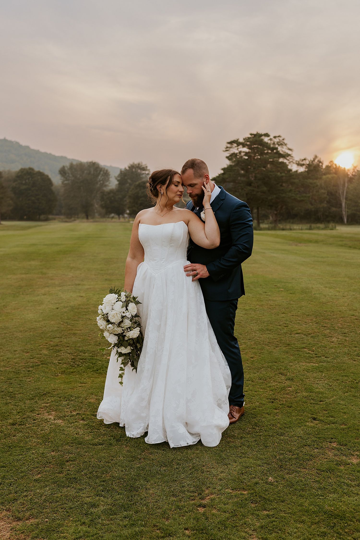 Bride and groom taking sunset portraits outdoors at their New Hampshire wedding - for a blog about wedding photography advice