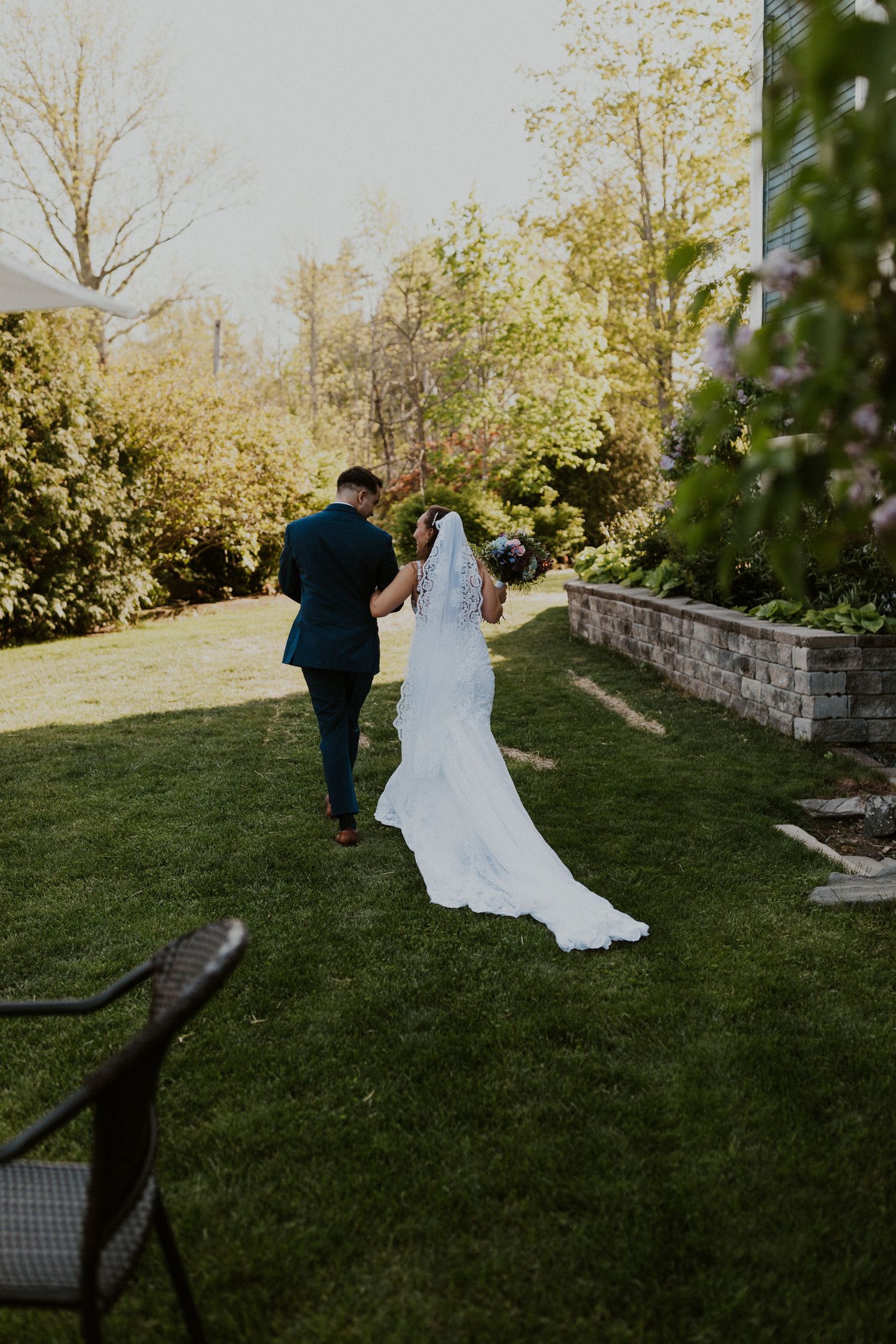 Chrissy and Mike walking away from the wedding party and enjoying a moment together as newlyweds.