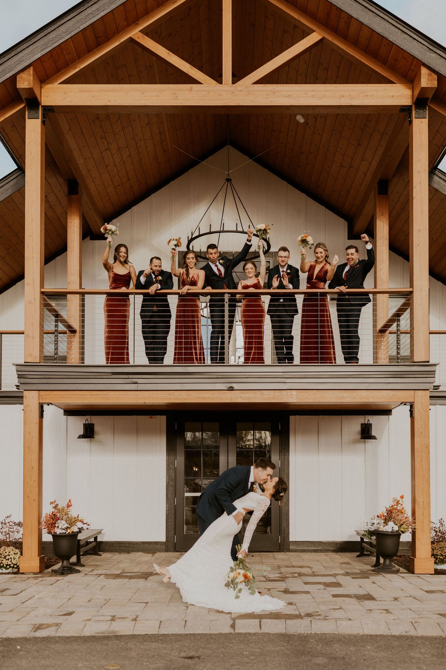 The whole wedding party posed on the new Lake House at the Owl's Nest Resort in Thornton NH.