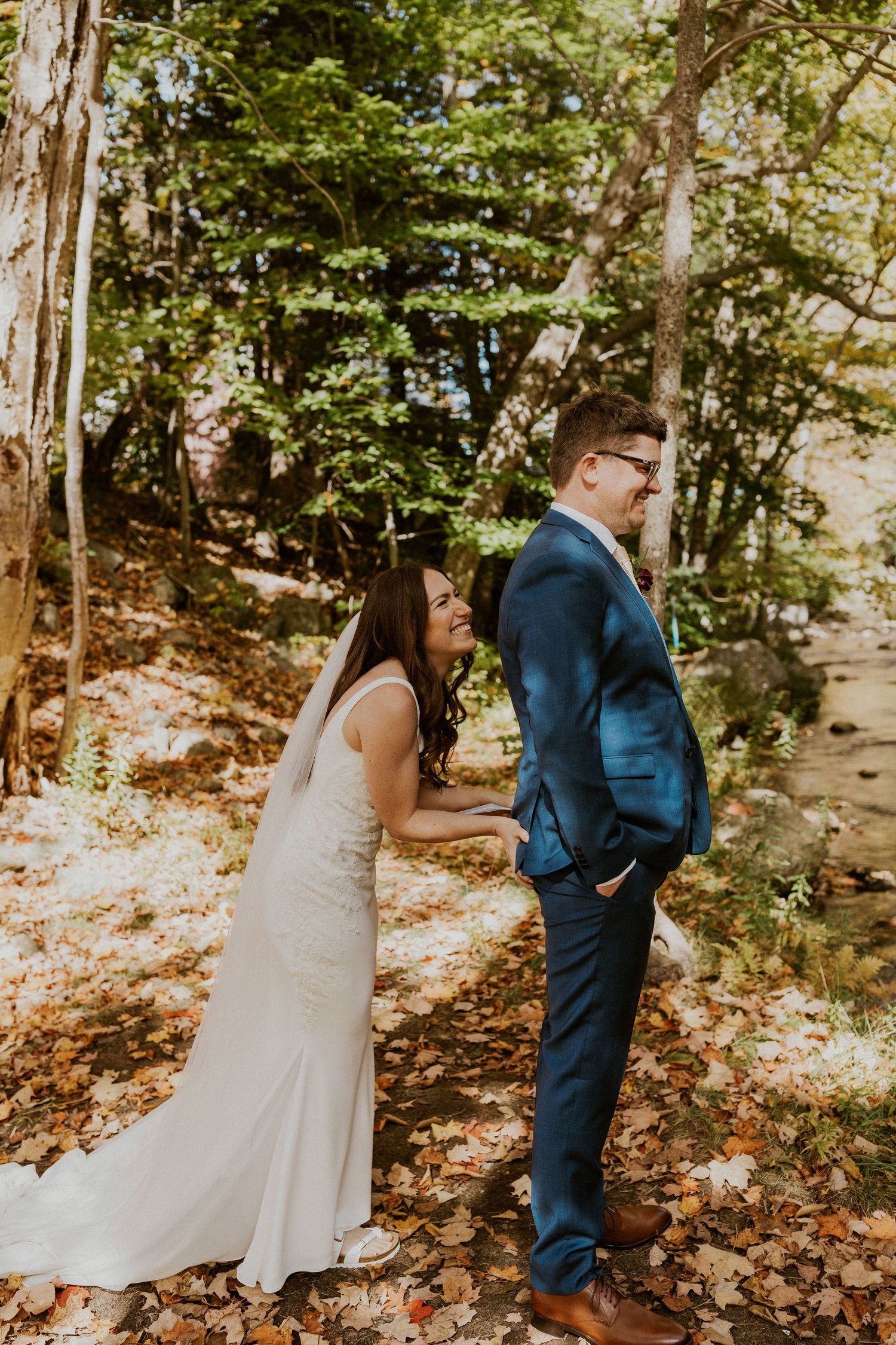 Briana squeezing Daniel's butt to signal that he can turn around and see her now.