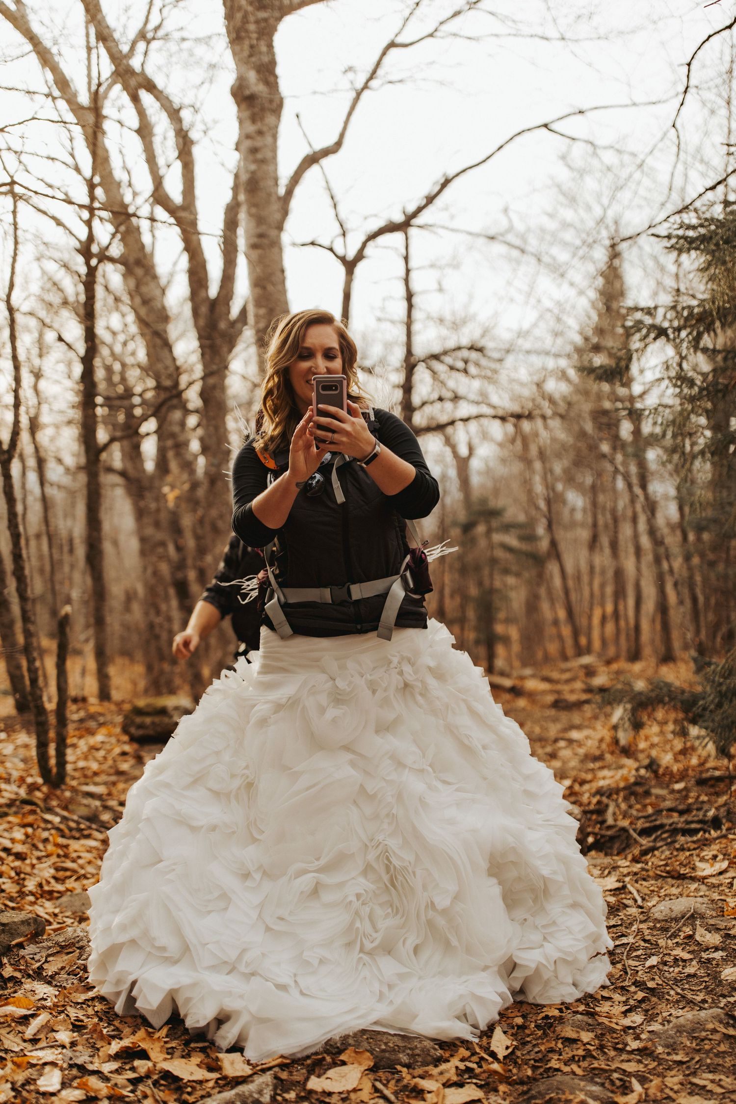 Jackie and Andy Brosonski hike the West Ridge Trail on Mount Cardigan in their wedding attire.