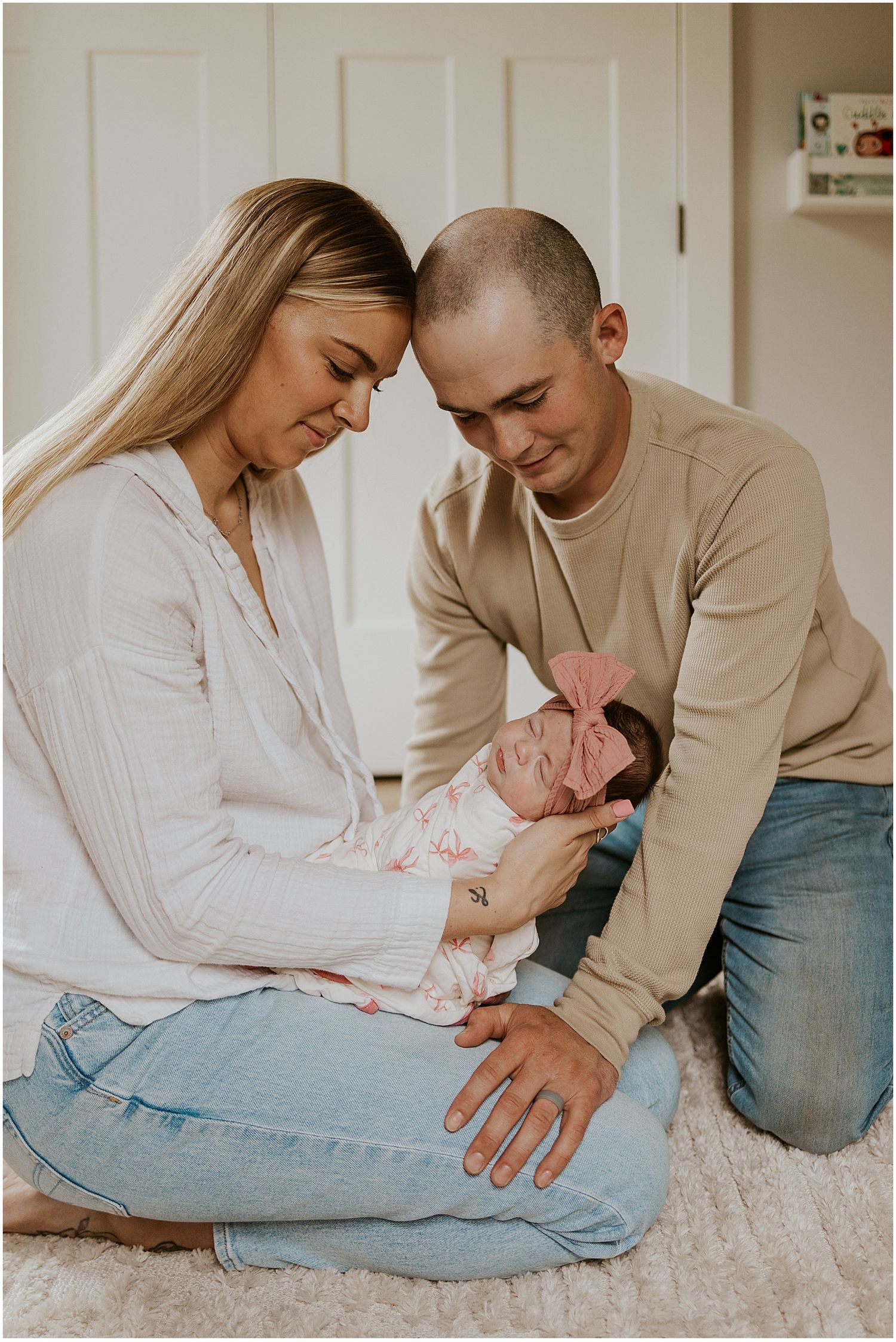 NH couple taking lifestyle newborn family photos in their home