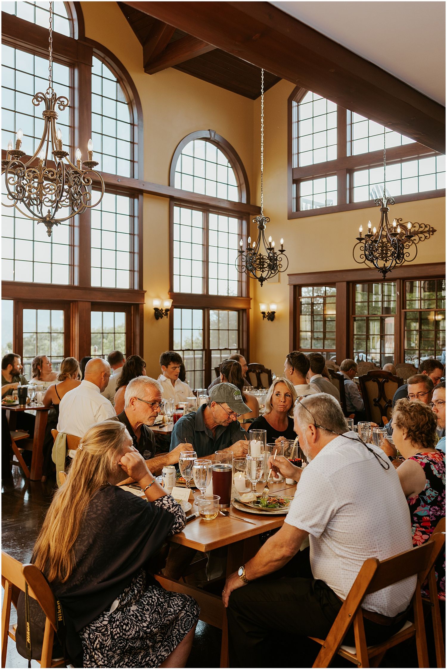 Guests enjoying dinner at a wedding reception at a VRBO in the mountains in Maine