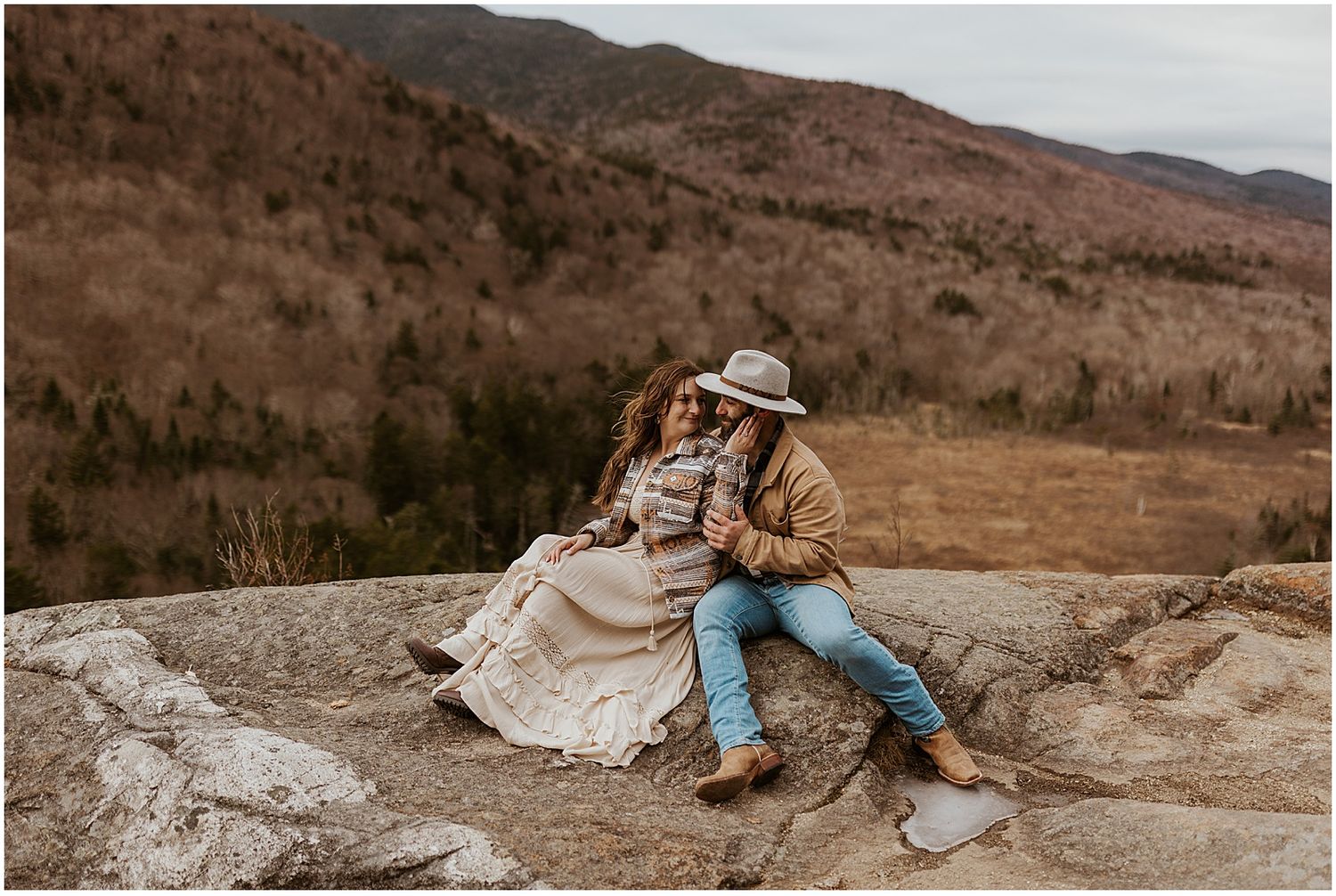 Couple taking boho engagement photos in the NH White Mountains