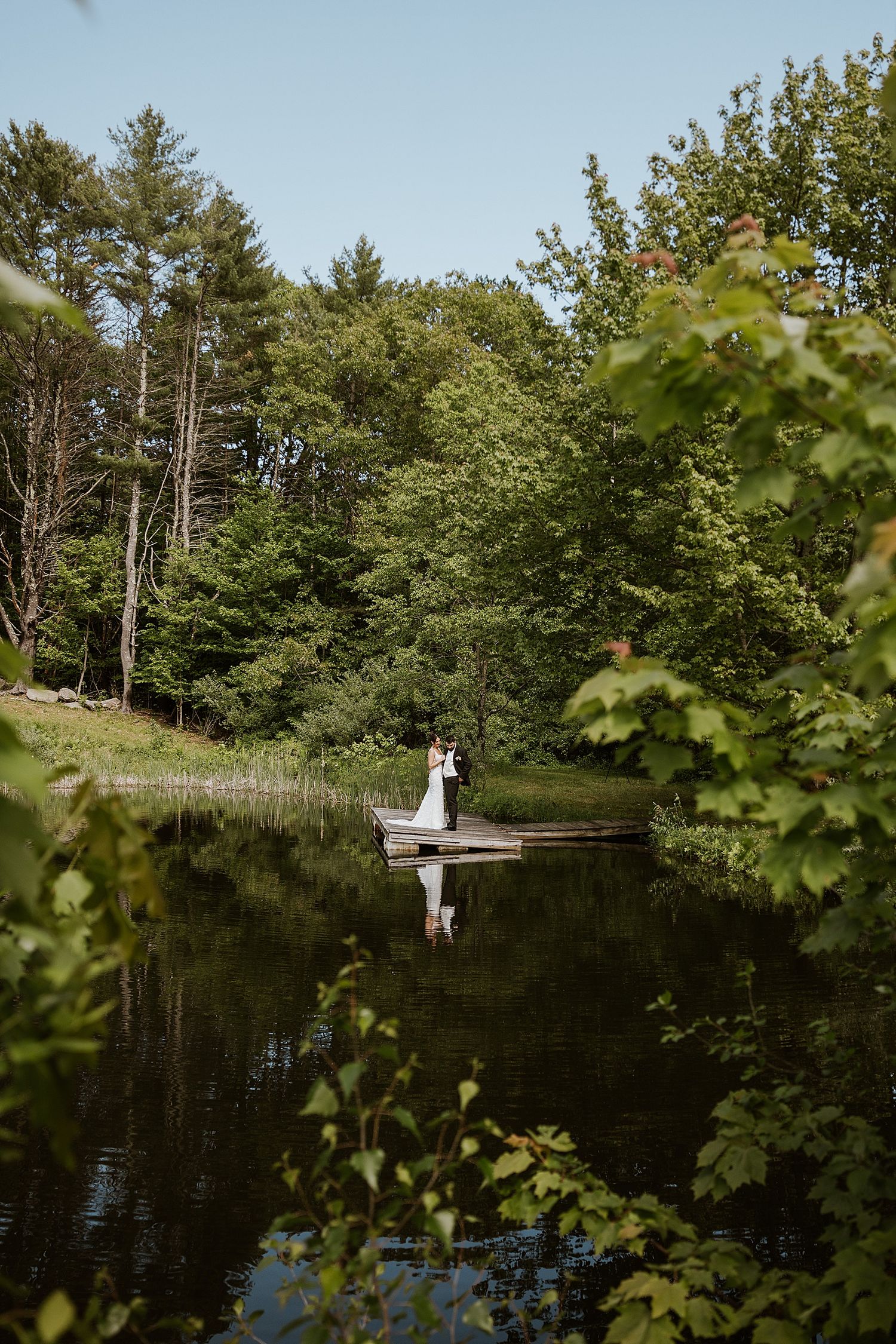 Bride and groom having their first look by the pond at Longlook Farm in NH
