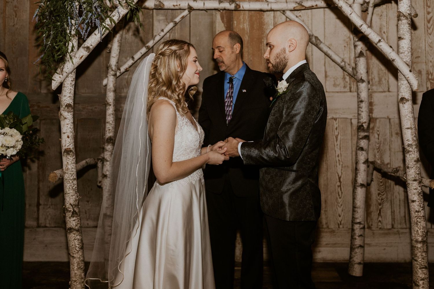 Deirdre and Brodie hand in hand during their wedding ceremony in Tamworth New Hampshire.
