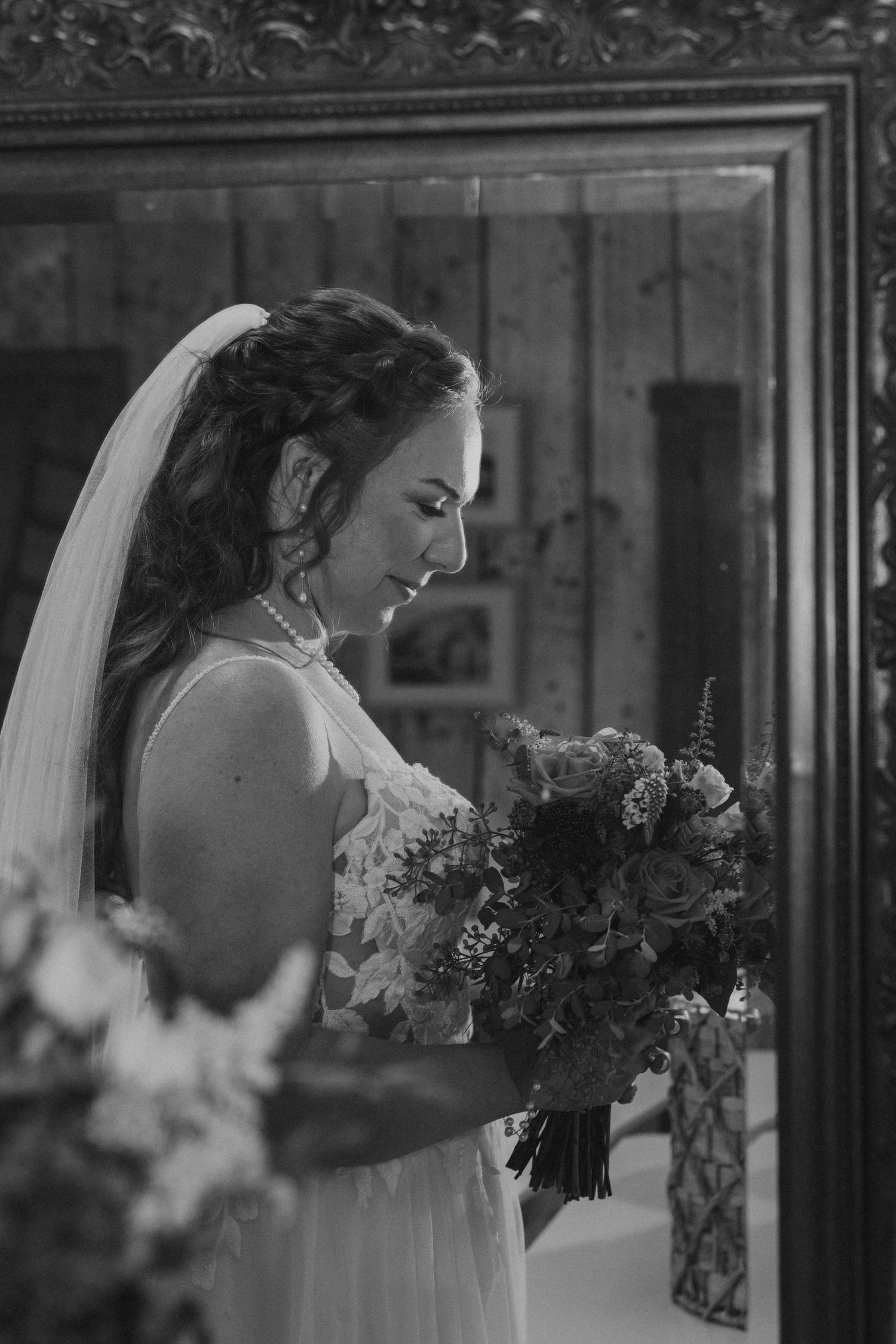 A series of black and white portraits showing a bride holding a bouquet in different poses against a dark background.