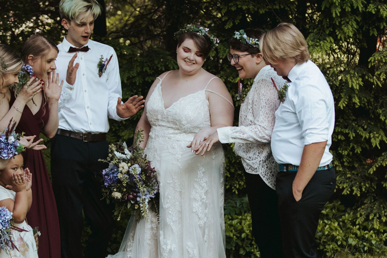 Wedding party shares laughs and joyful moments during outdoor celebration.