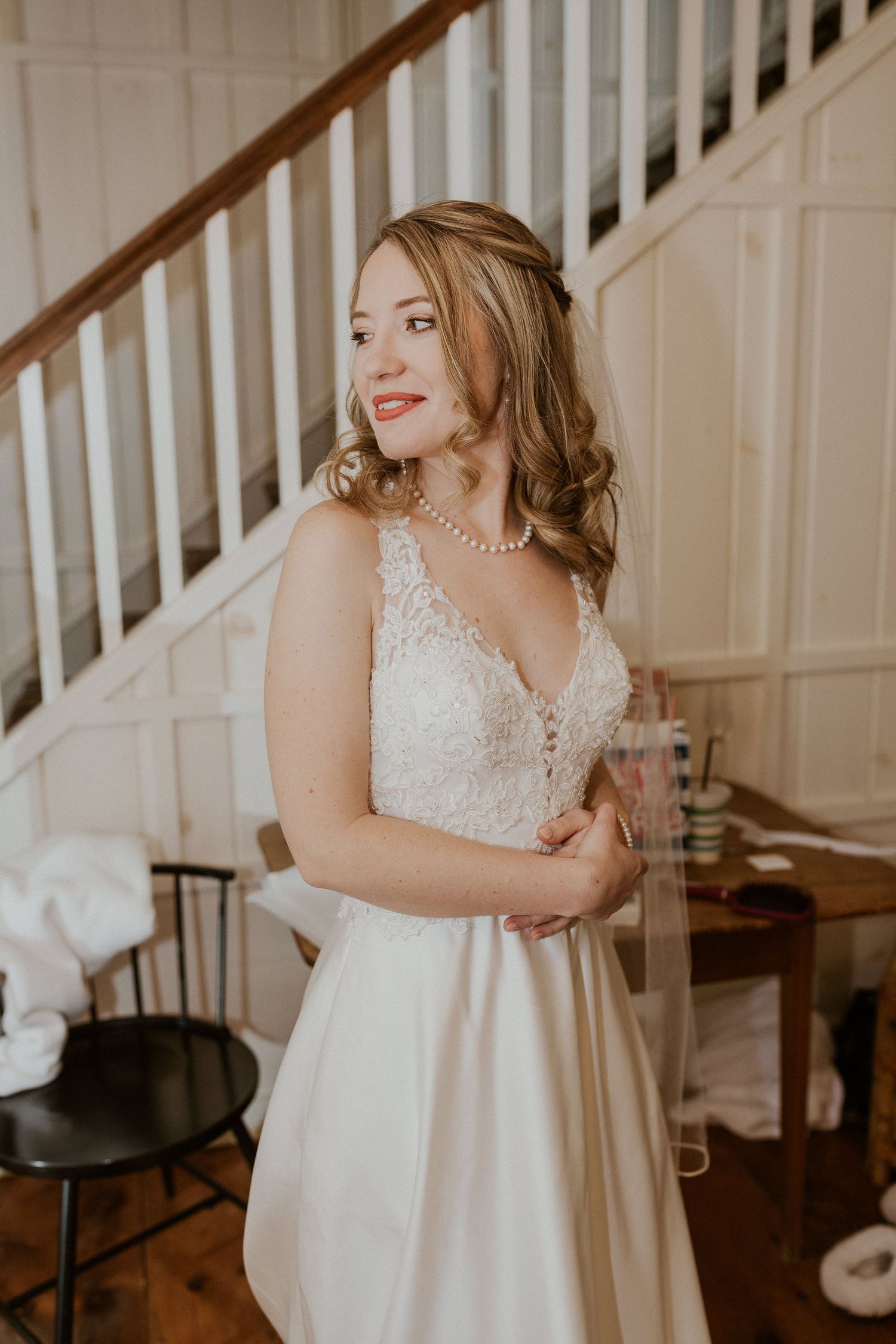 Deirdre looking at herself in the mirror for the first time since putting on her dress.