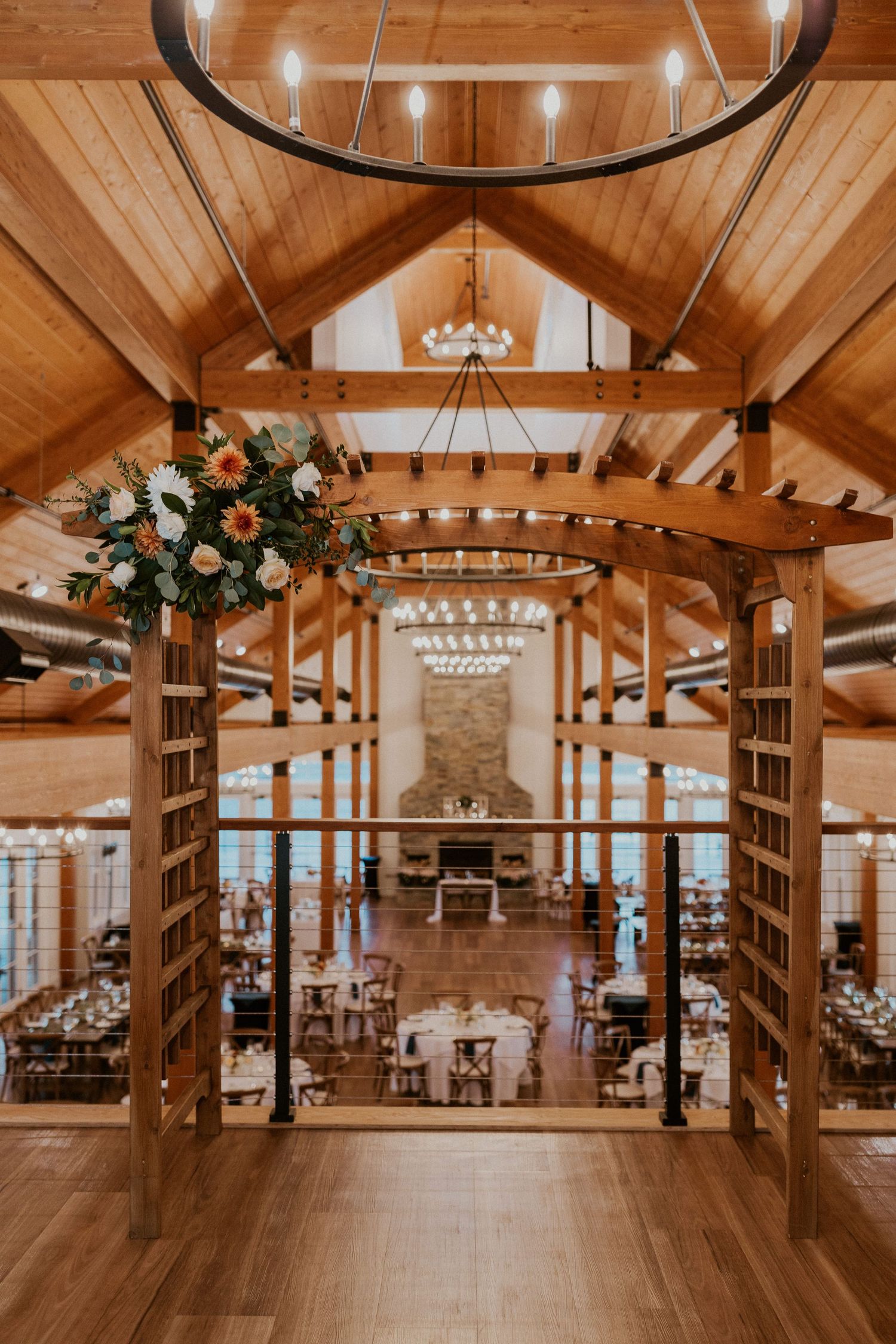 Indoor ceremony space at the Owl's Nest Resort in Thornton, New Hampshire. A small floral piece by Lyndsey Loring Design