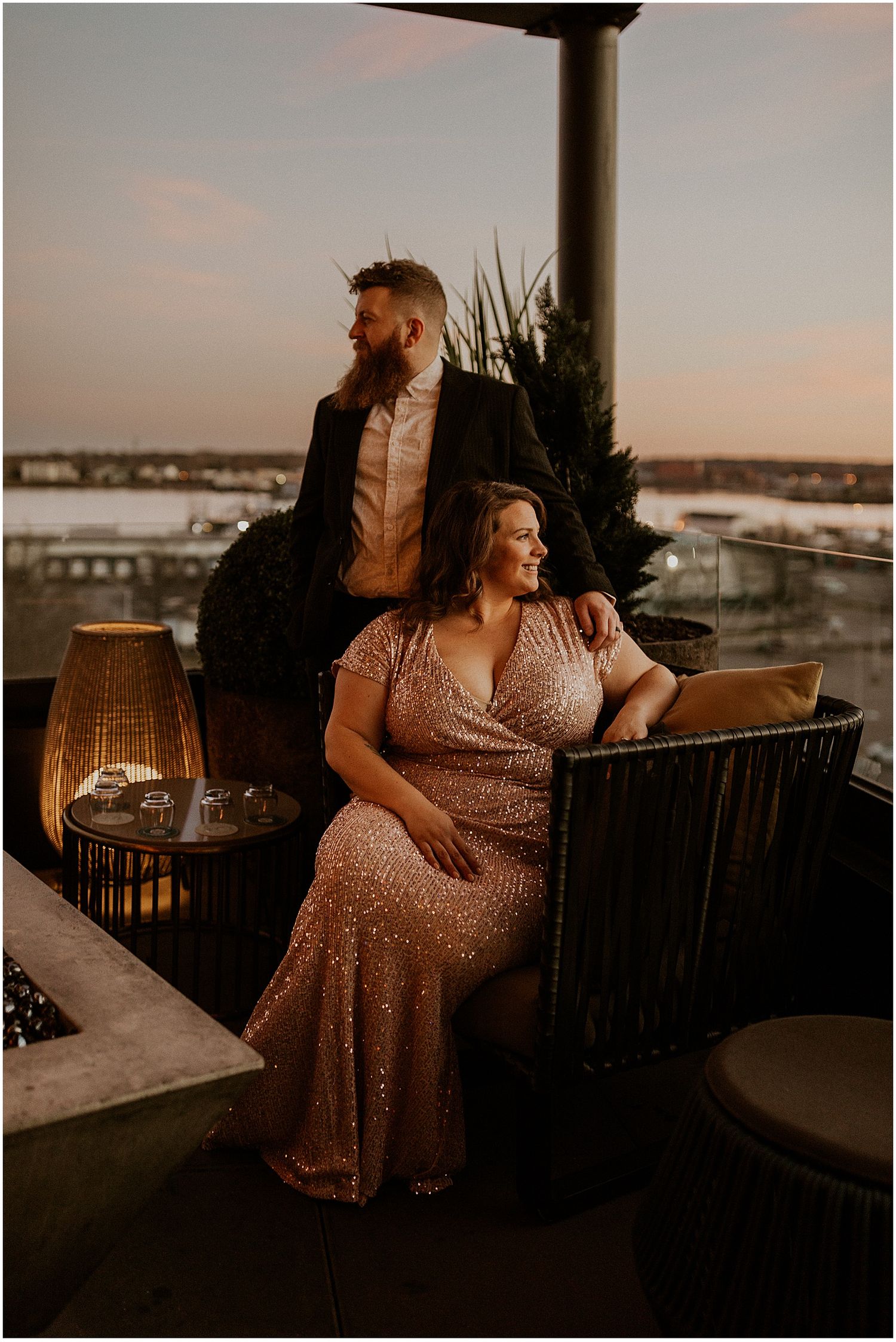 New England couple taking engagement photos at a rooftop bar in Portland, Maine