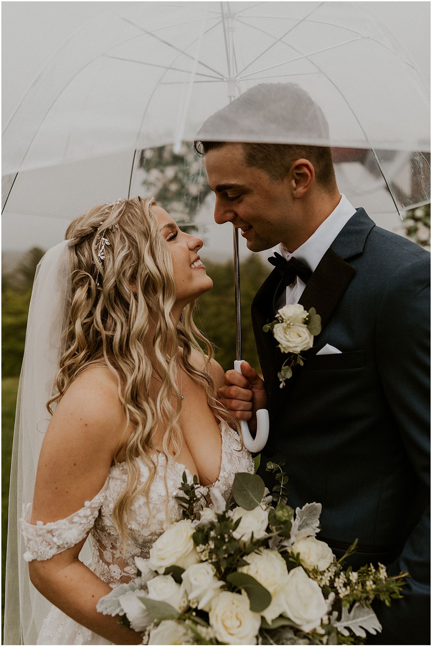 Bride and groom portraits in the rain at their rainy NH wedding