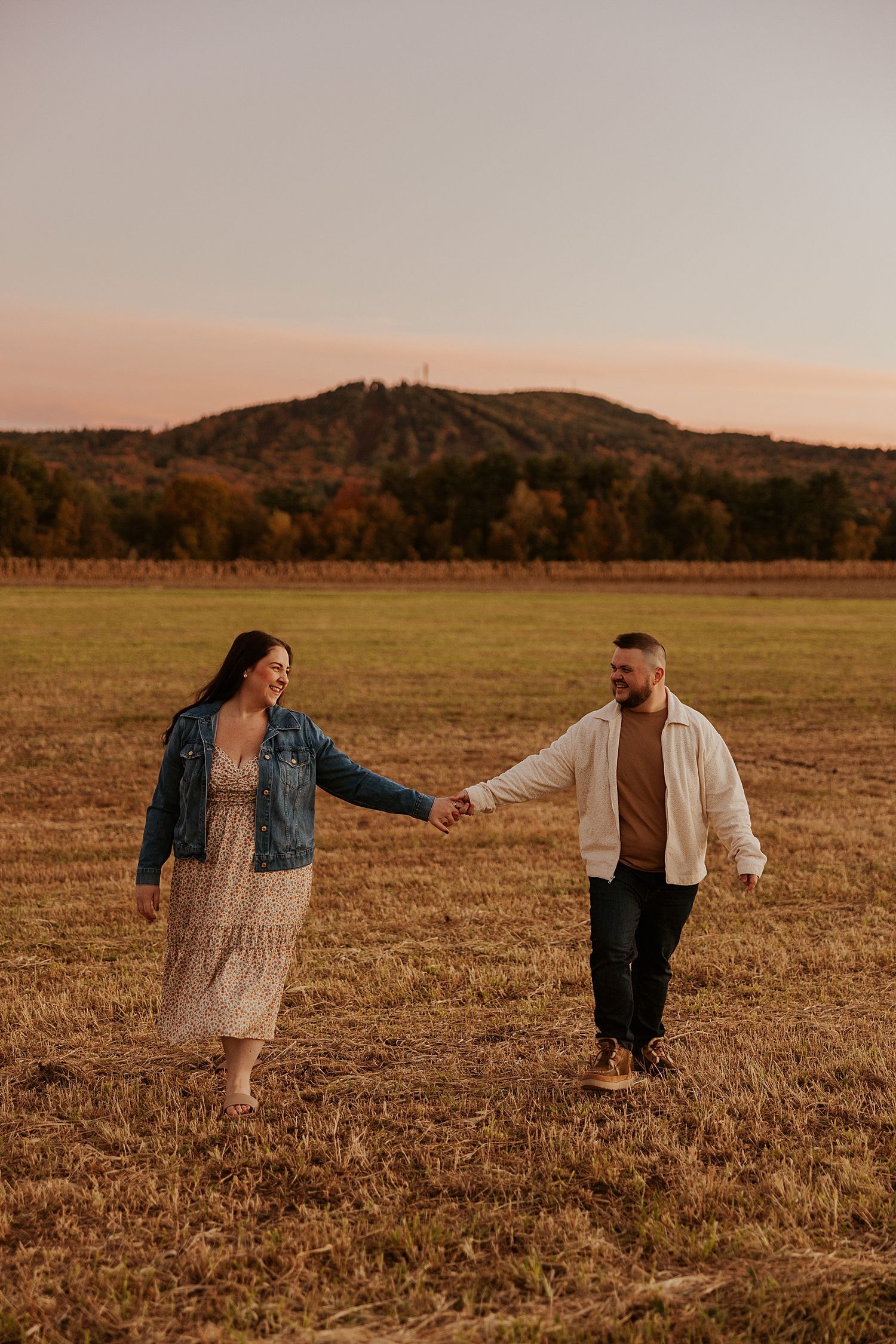 Couple taking portrait photos in the fall in New Hampshire