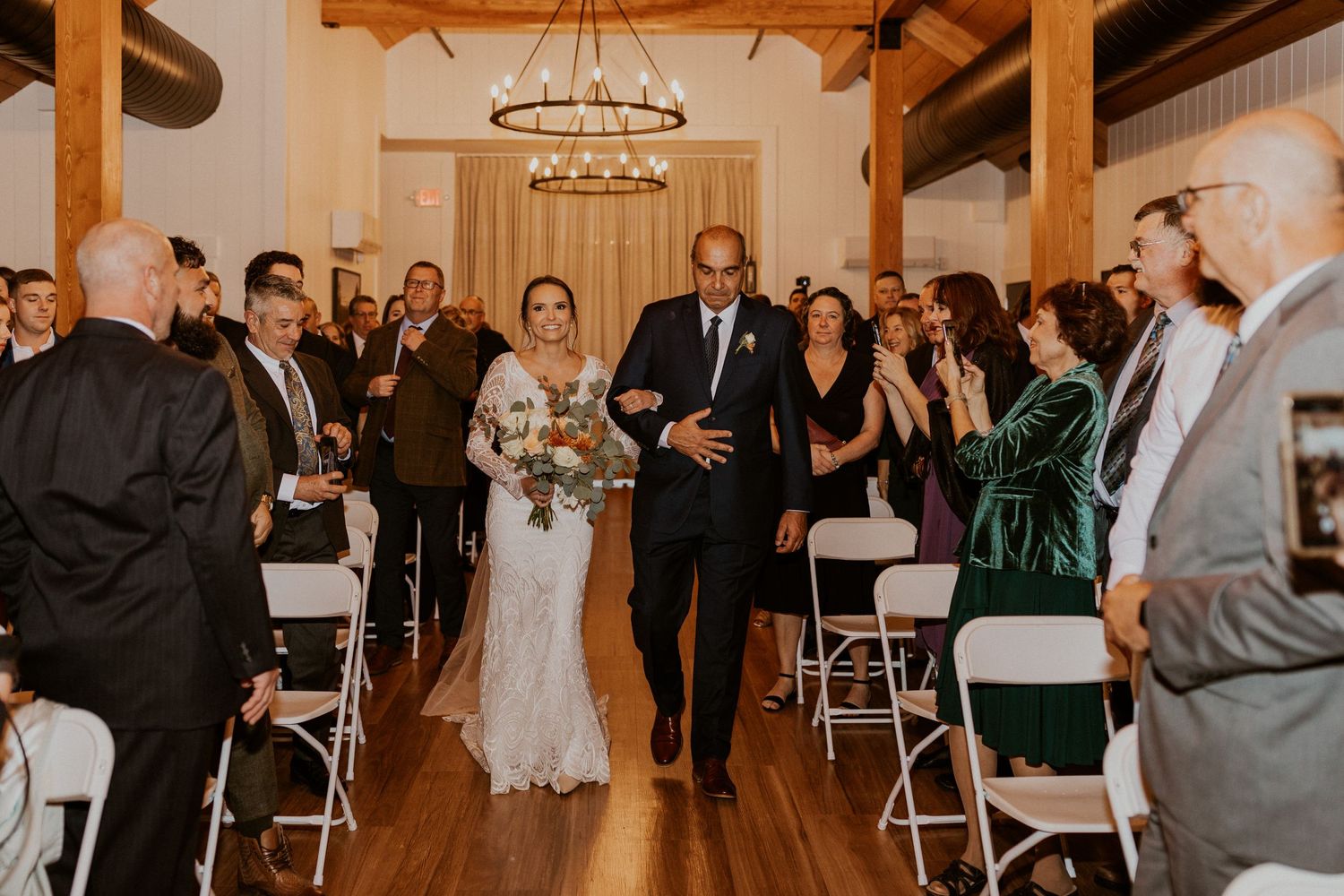 bride and her father walking down the aisle during the ceremony.