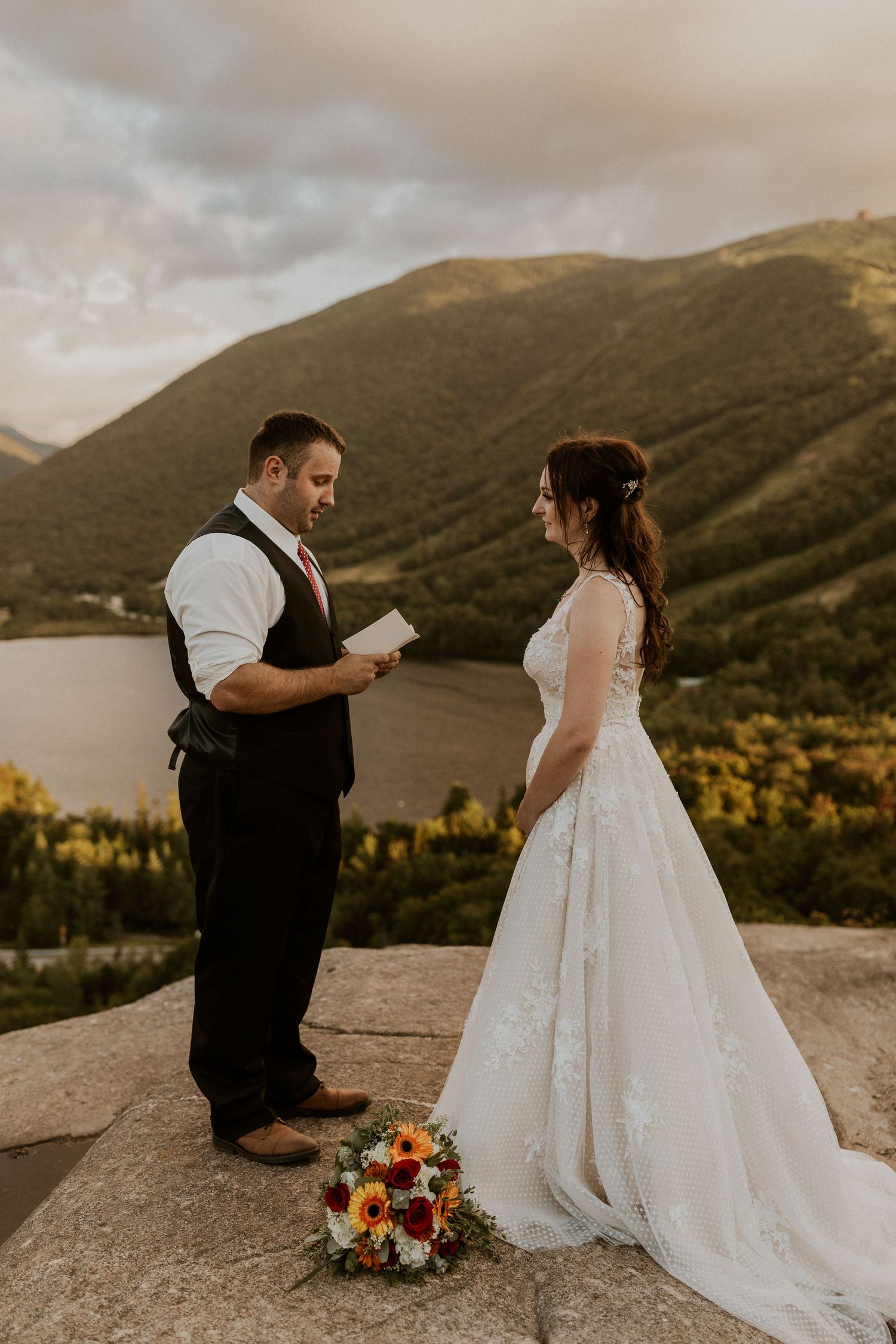 The groom sharing his private vows with the bride on top of Artist Bluff in Franconia New Hampshire.