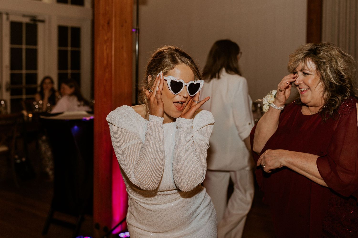 The bride dancing and enjoying the night with her sunglasses and glamorous reception dress!