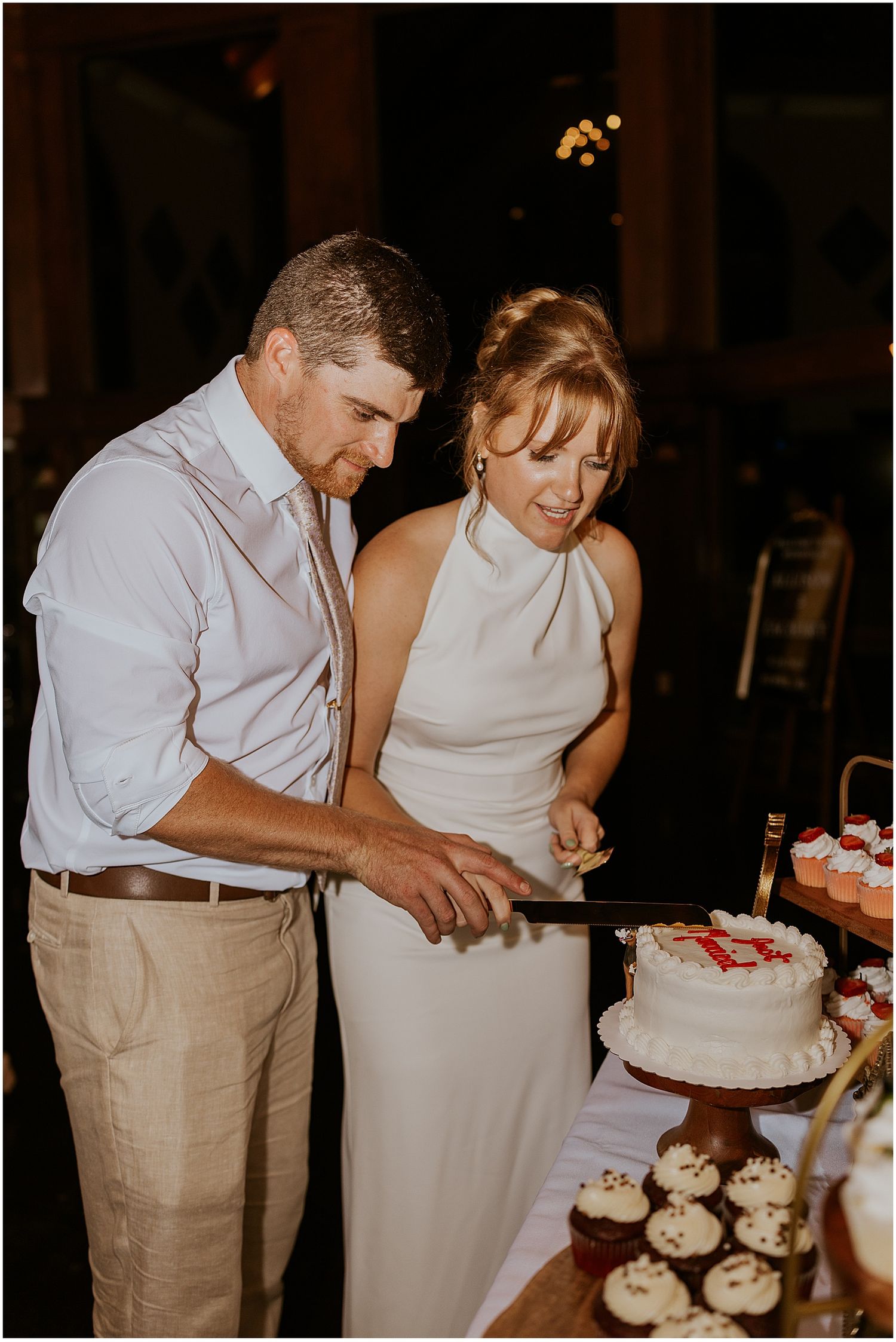 Bride and groom cutting the cake at their Maine wedding