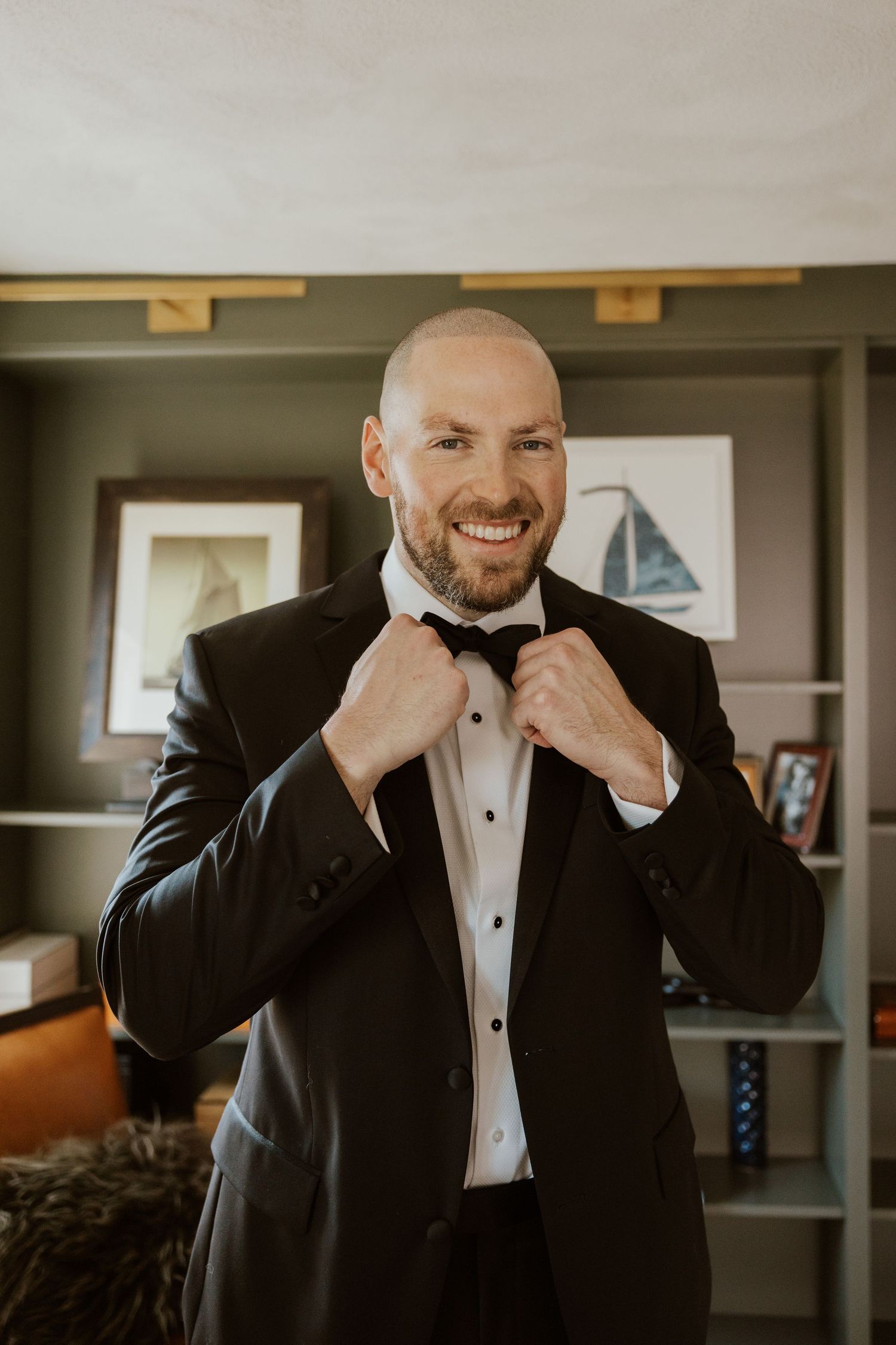 A series of photos showing someone adjusting a black bow tie while wearing a formal tuxedo.