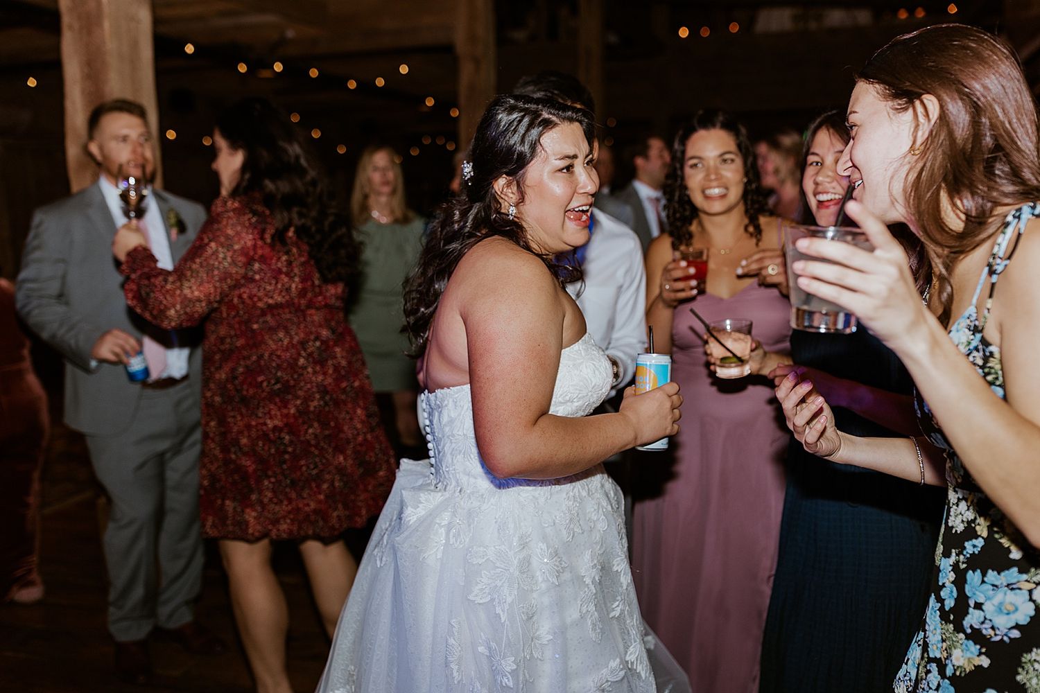 Bride dancing and laughing with her guests at a NH wedding