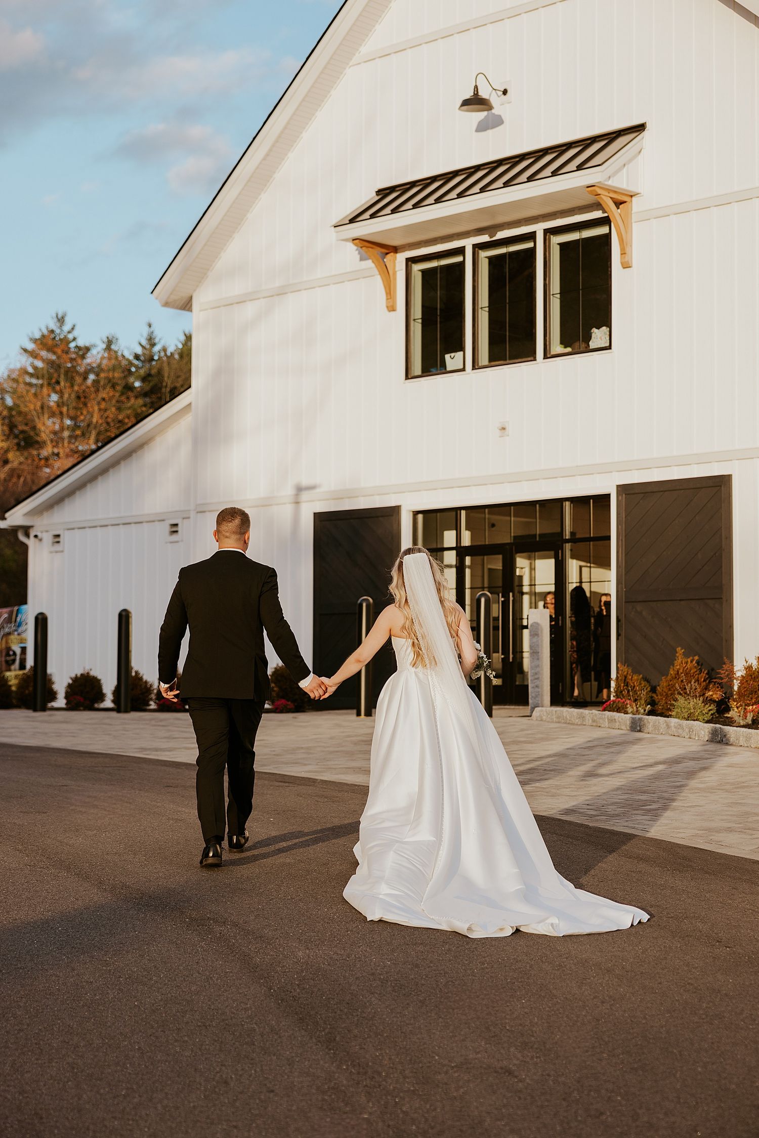 Bride and groom holding hands and walking back in to their Hyla Brook Estate wedding ceremony