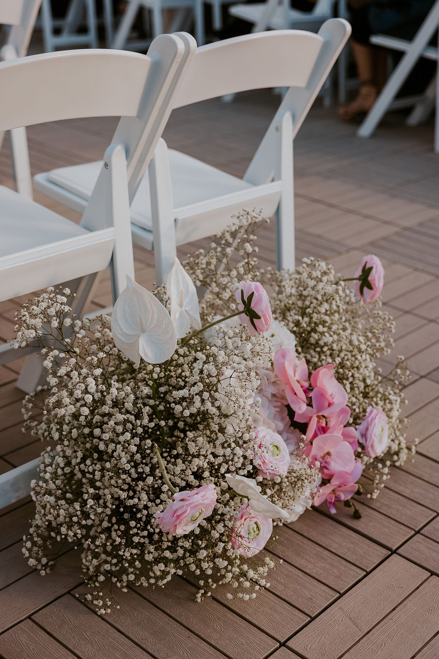 Pink and white wedding ceremony floral arrangement for a Hyla Brook Estate wedding