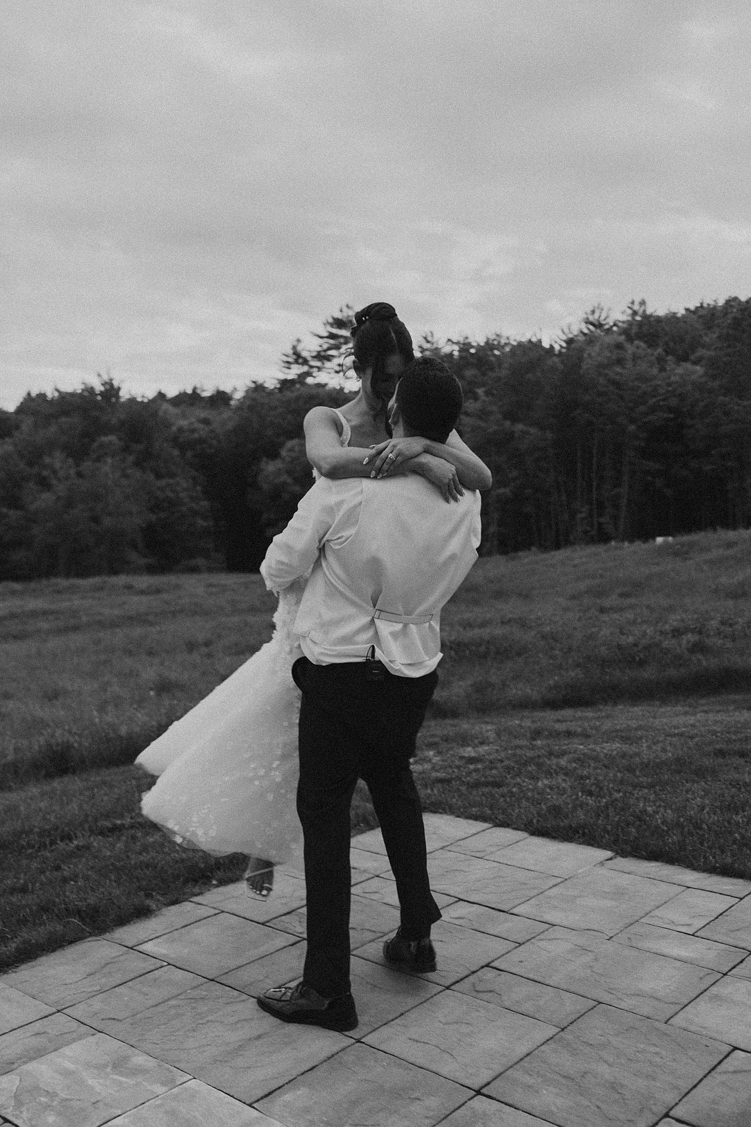 Bride and groom taking portrait photos outside at Longlook Farm in NH