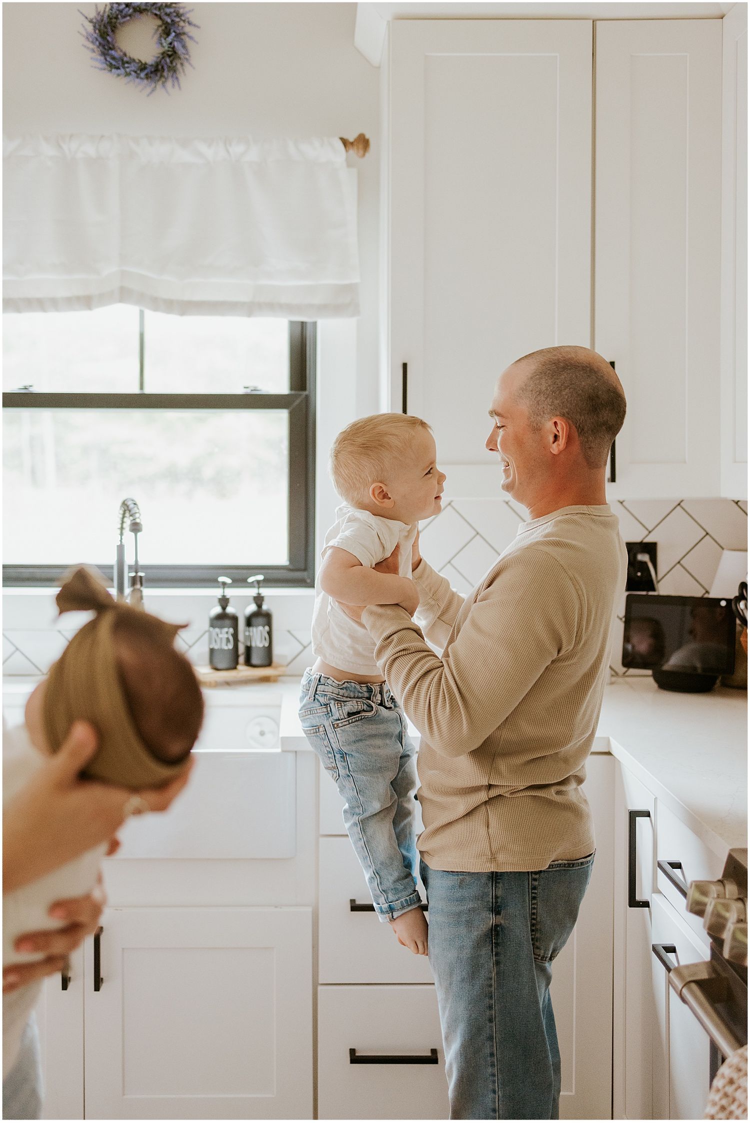 NH family at home taking photos with their newborn baby