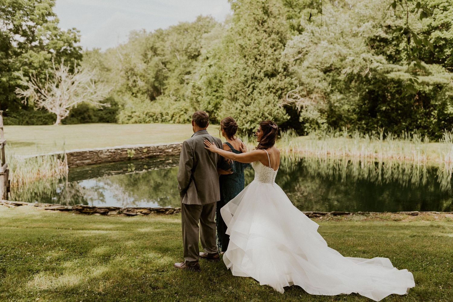 Jessica sharing a special moment with her parents, revealing her wedding gown.