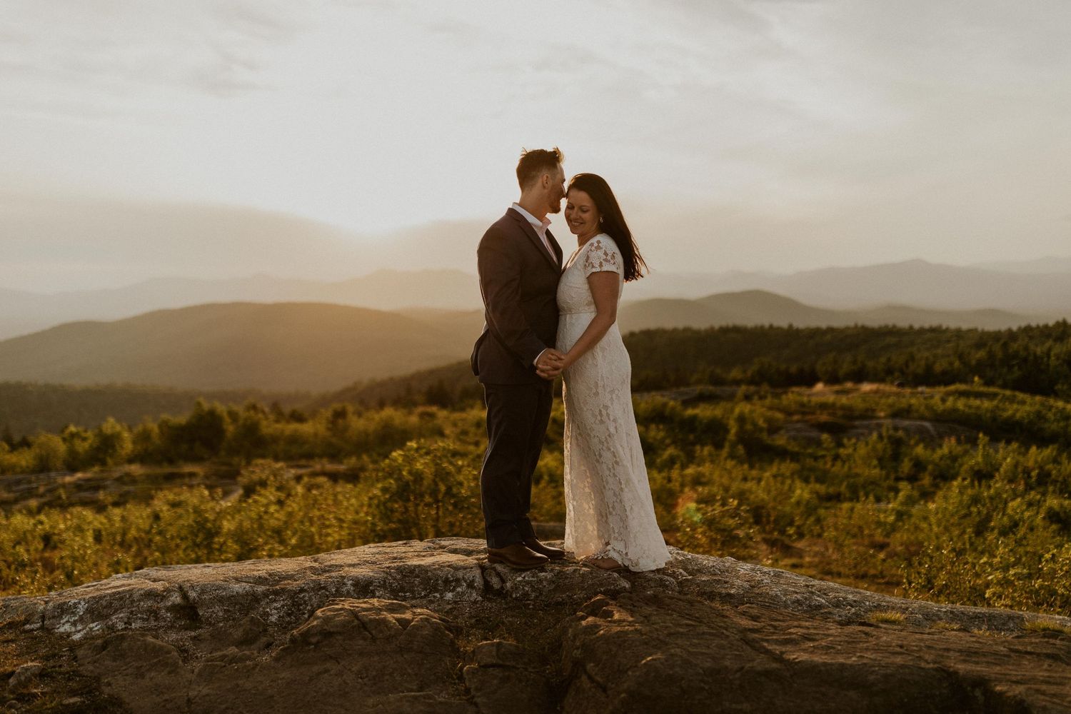Danielle and Colin dressed in their wedding attire for their one year anniversary photoshoot on Foss Mountain in NH.