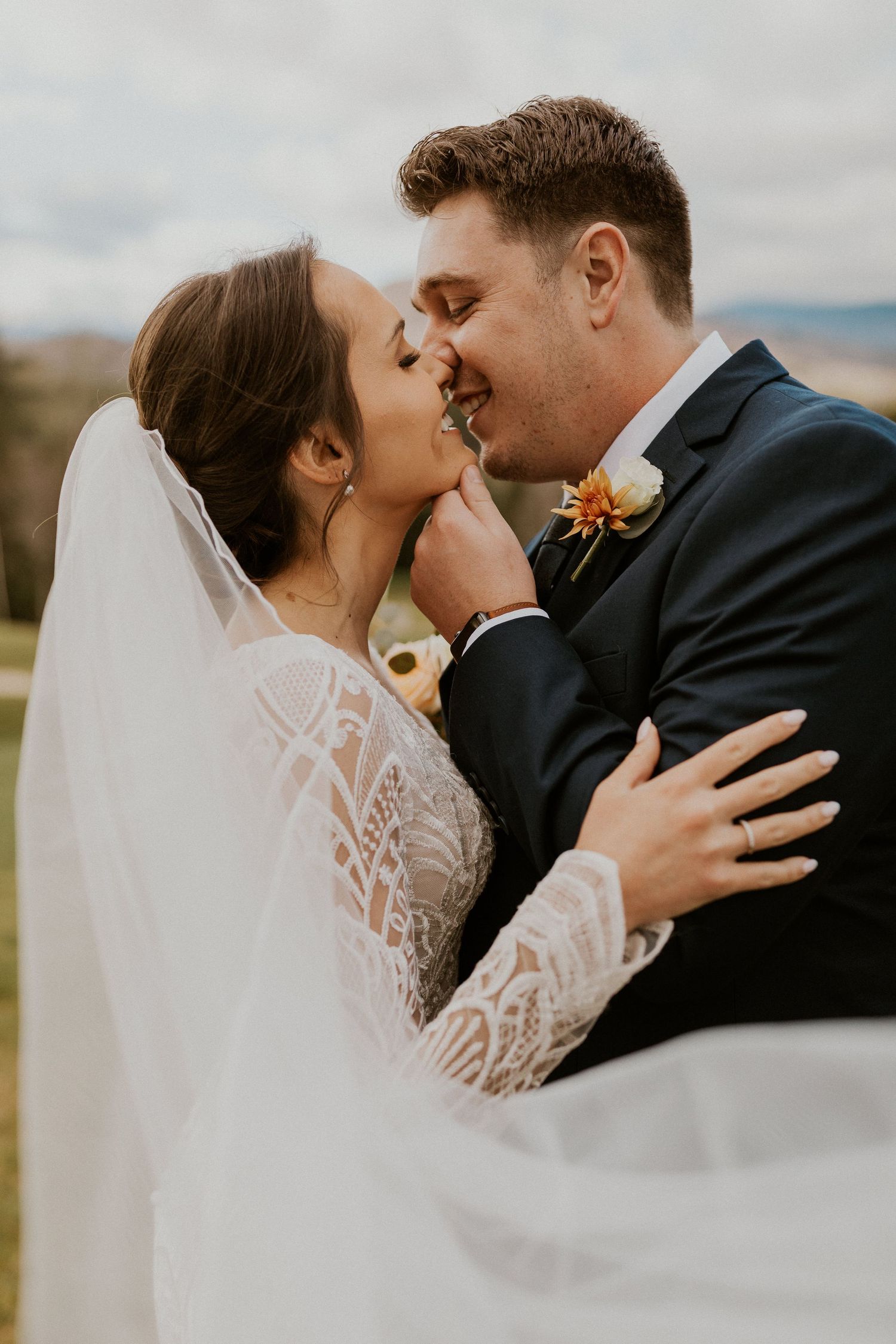 Portrait of the bride and groom intimately kissing at Owl's Nest Resort in Thornton, New Hampshire.