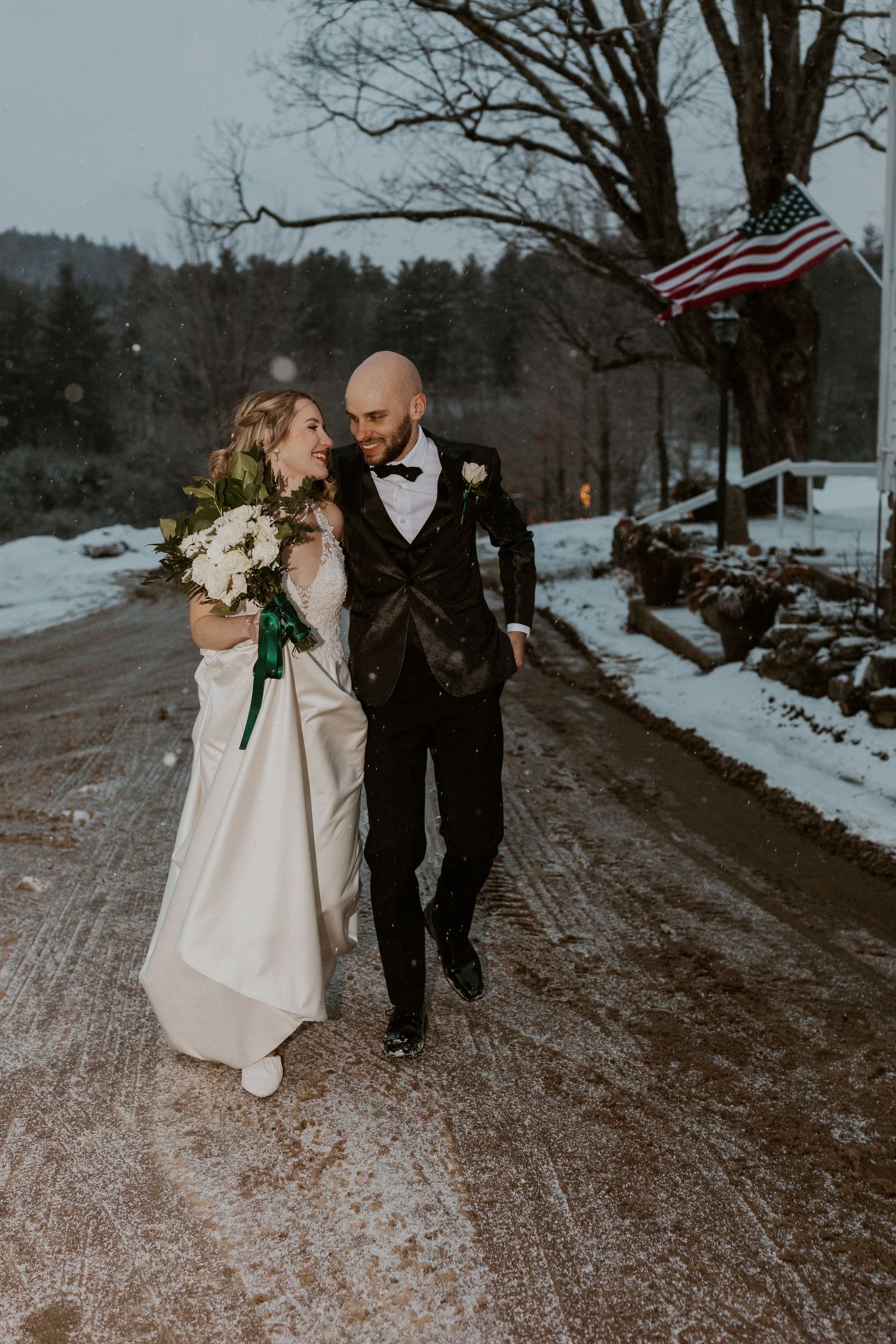 Deirdre and Brodie walking back to their wedding reception after braving the elements for moody wedding portraits.