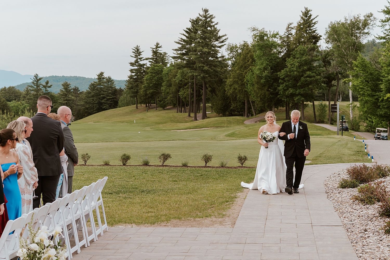 Bride walking down the aisle with her father at her New Hampshire wedding at Owl's Nest Resort