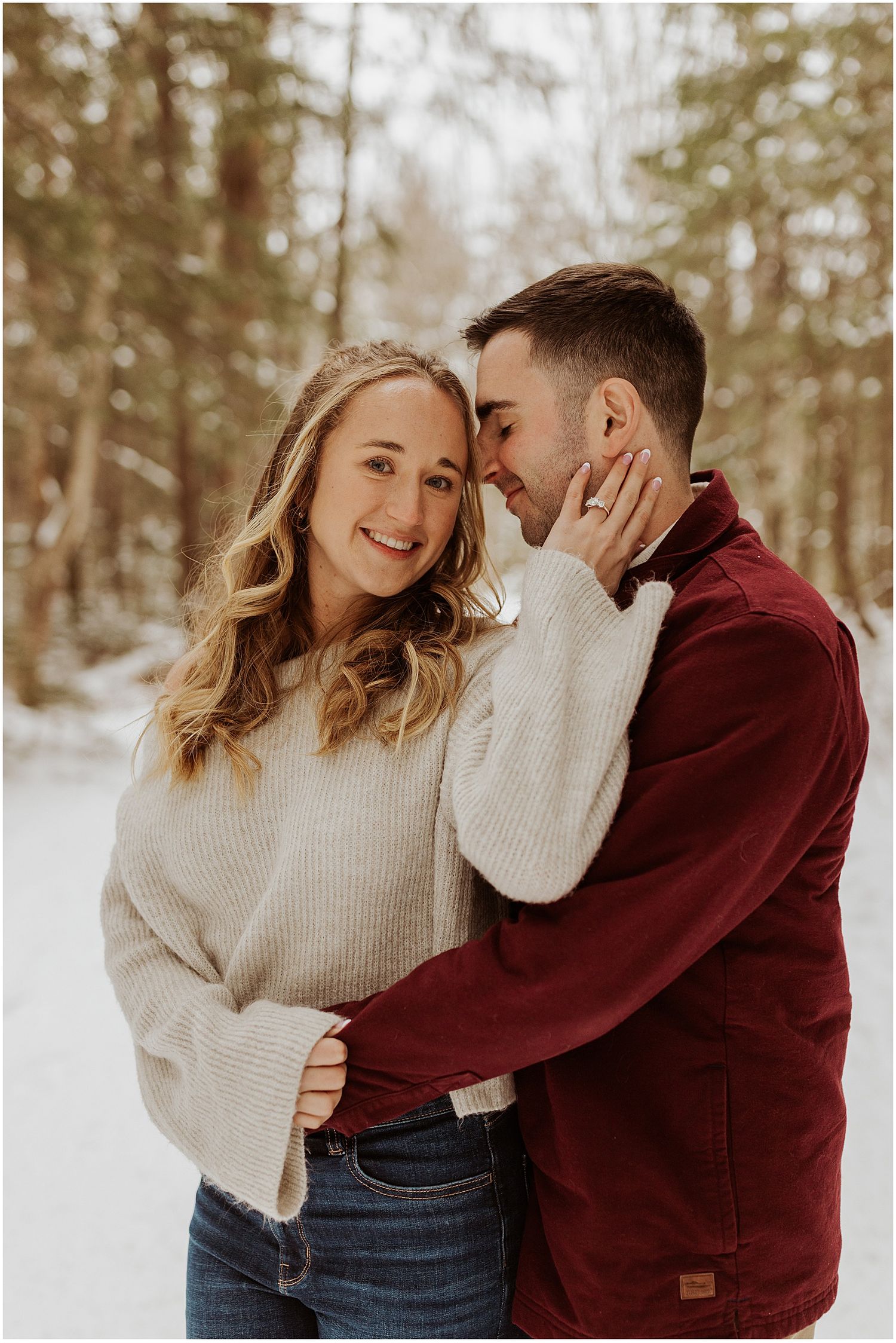 Couple sharing joyful moments in a winter setting wearing casual attire.
