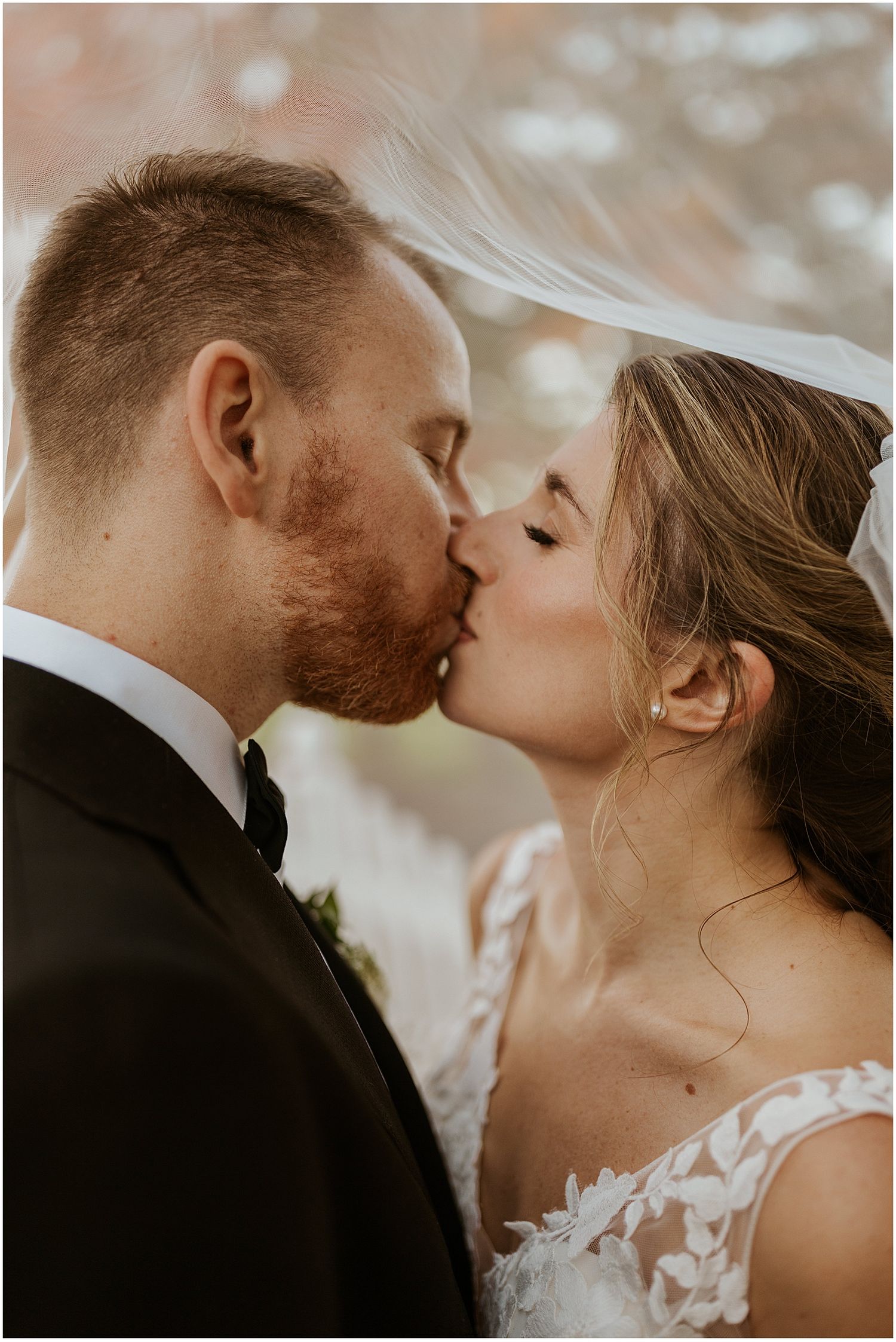 Intimate wedding portrait captured during golden hour with soft natural lighting.
