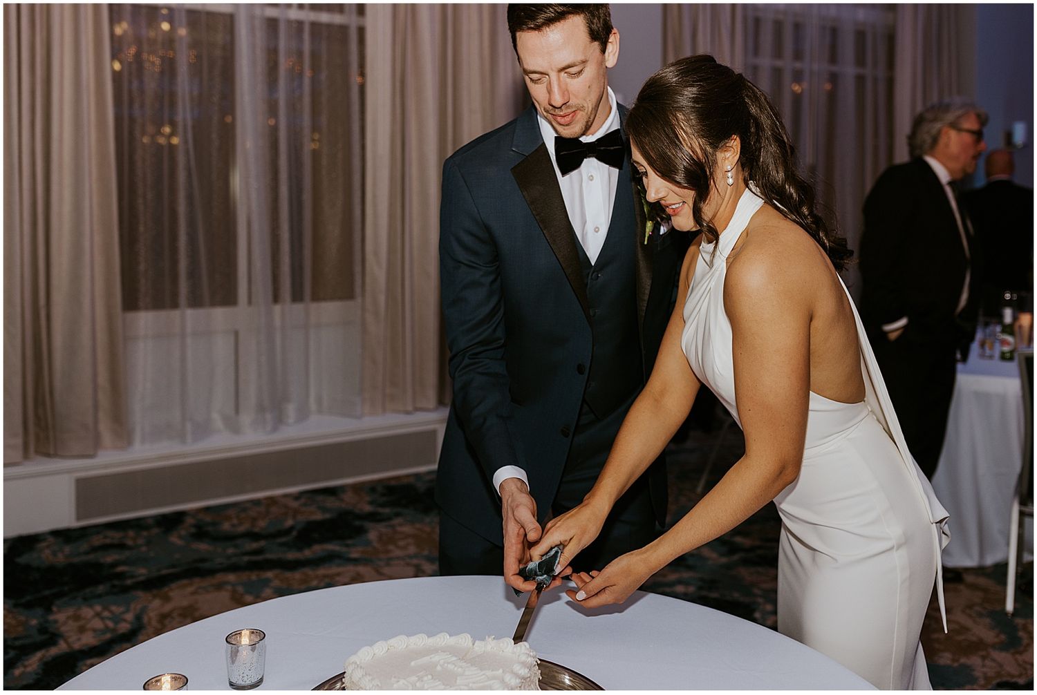 Bride and groom cutting the cake at their Loon Mountain wedding at the River Walk Resort