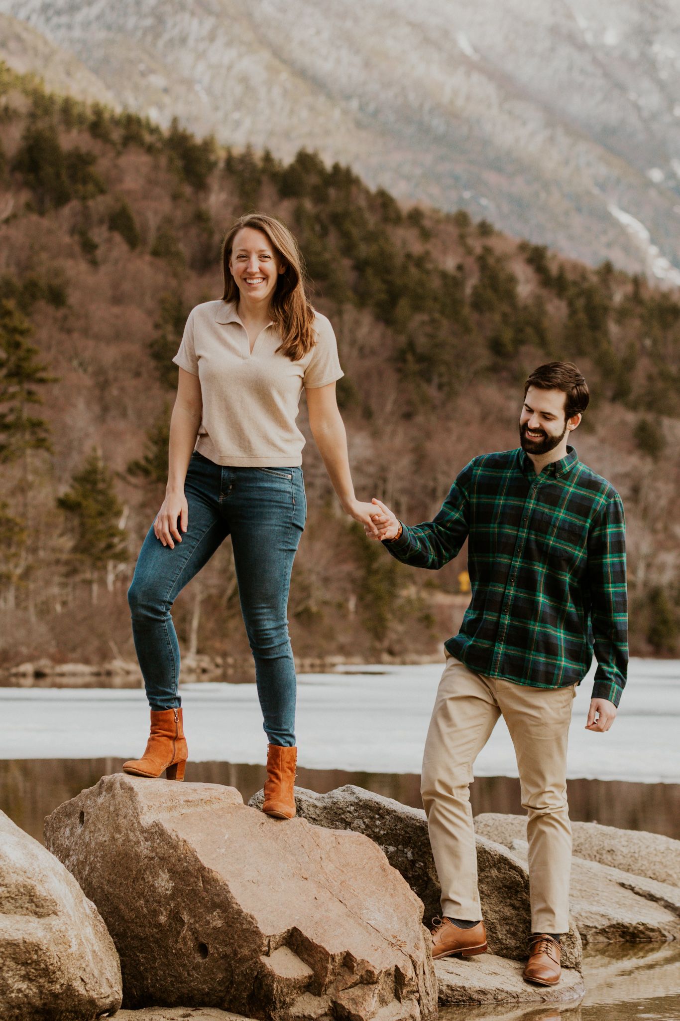 A happy couple standing in front of Echo Lake in Franconia Notch State Park