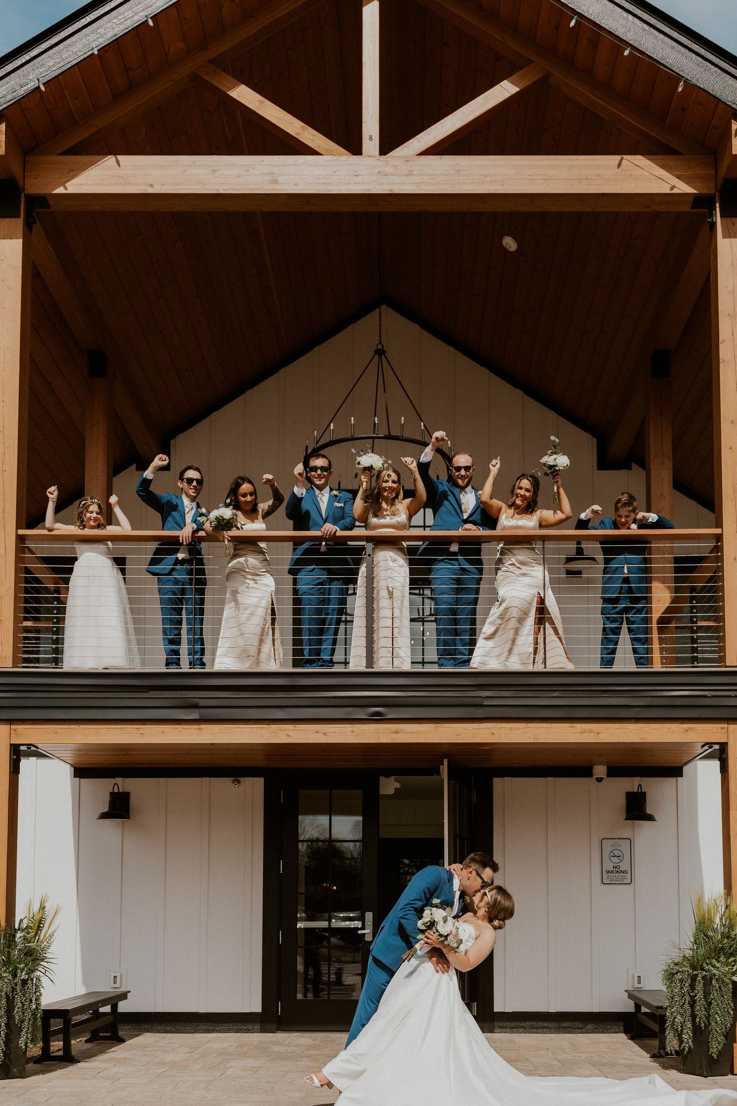 Wedding party photo on the lake house balcony at owl's nest resort in thornton new hampshire.