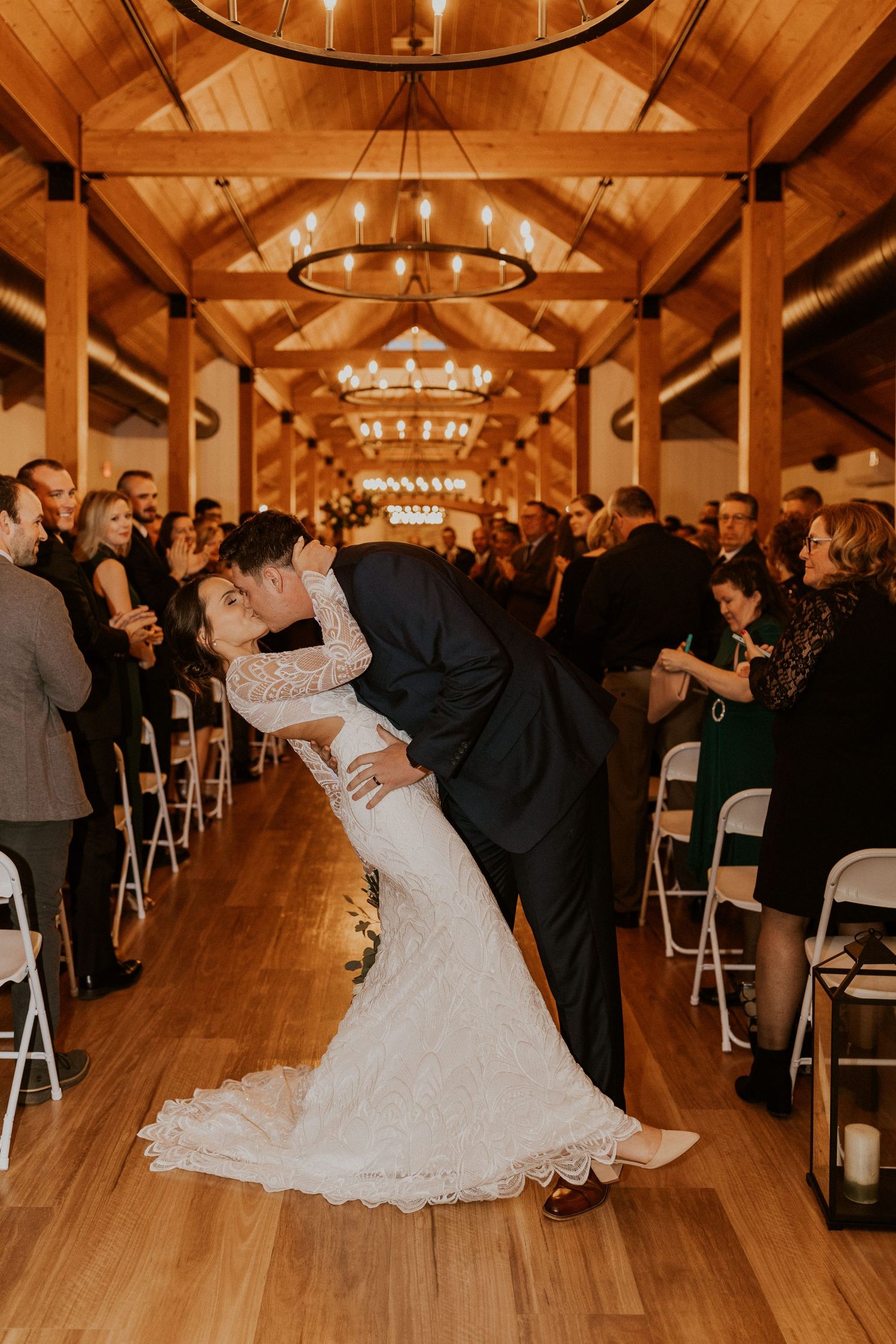 Bride and groom sharing their first kiss in the new Lake House at Owl's Nest Resort in Thornton NH